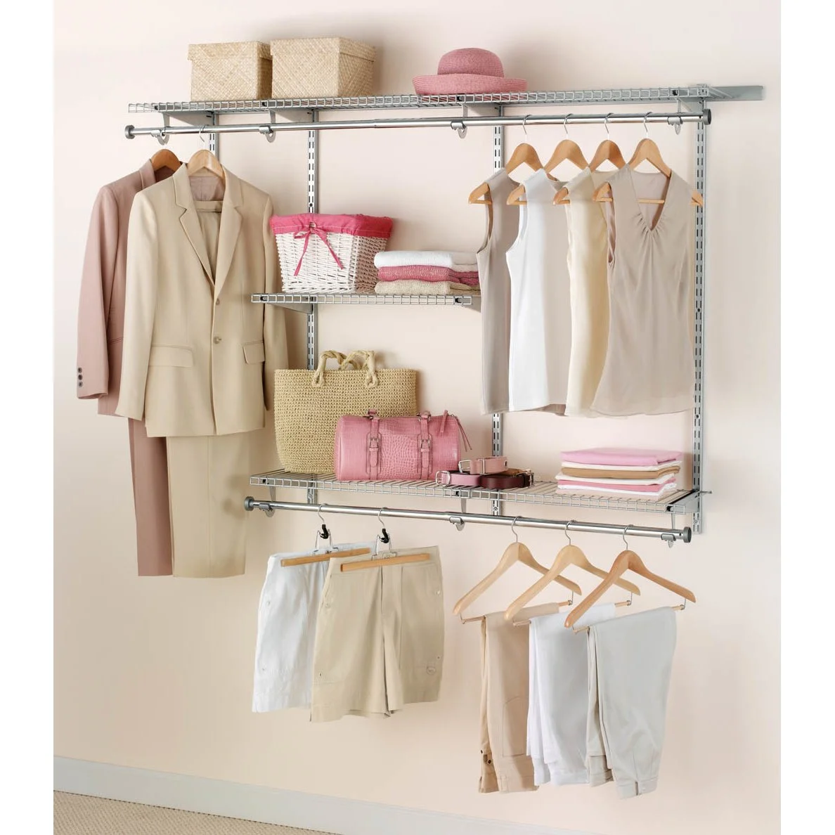 A minimalist closet organizer with clothing, handbags, and accessories in neutral and pink tones.