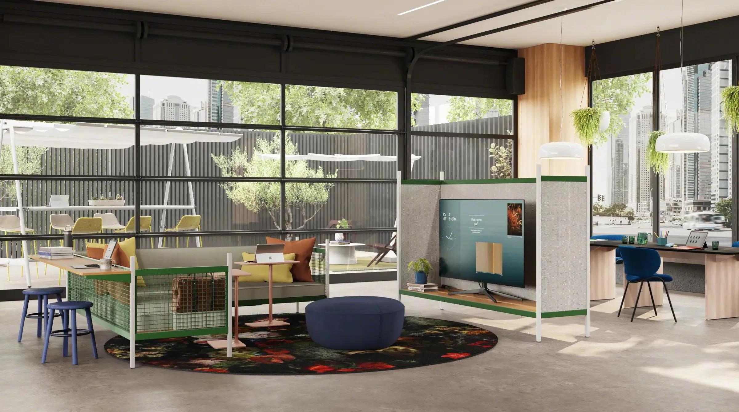 Modern open office space with glass walls, outdoor view, sitting area with colorful pillows, round rug, and workspace with desks, chairs, and potted plants.