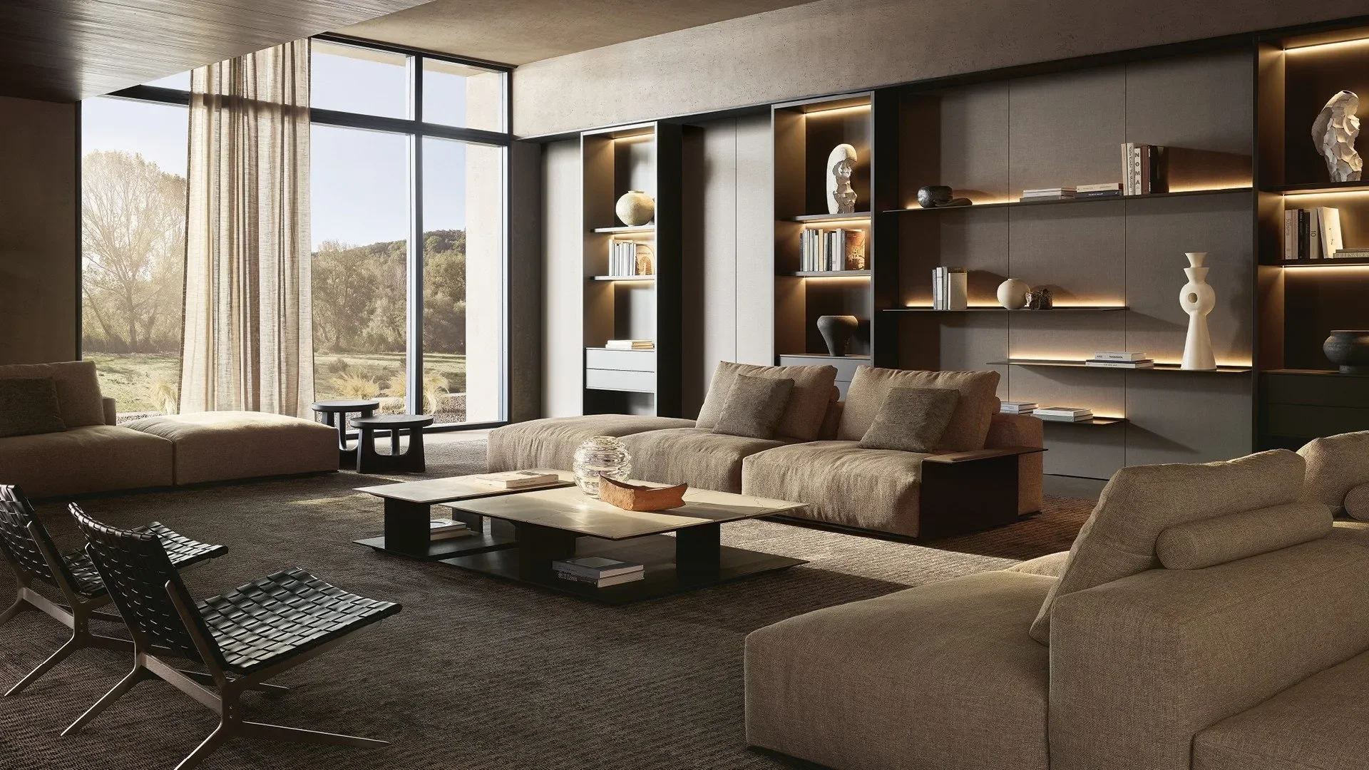 Modern living room with large floor-to-ceiling windows, beige sofas, and built-in shelves with decorative items and books.