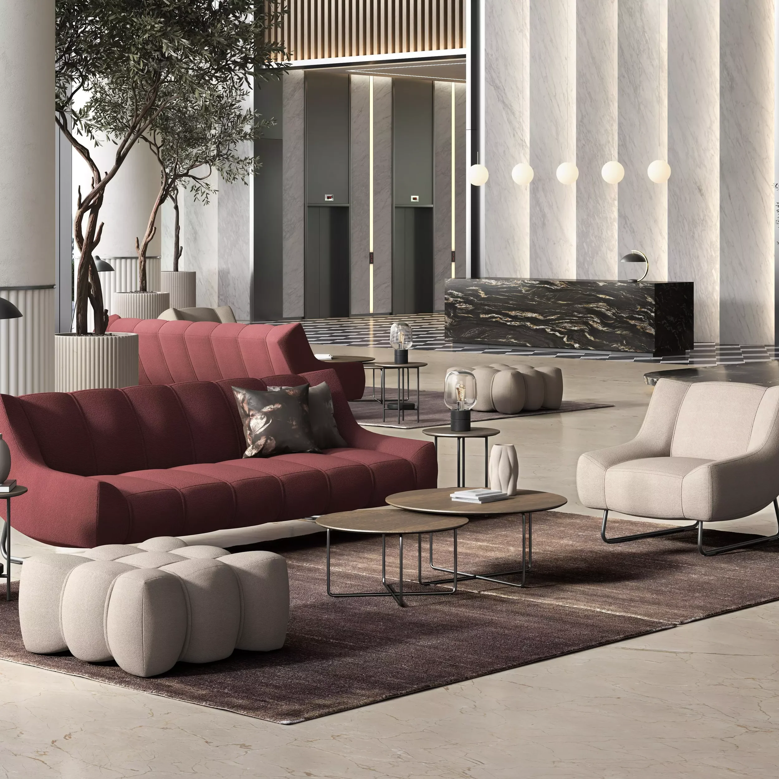 Modern hotel lobby with a burgundy sofa, cream armchair, and matching ottoman, around small coffee tables, with decorative lamps, beige stone floors, and a reception desk with black marble finish. Tall trees in white planters are near the wall, and an elevator bank is in the back.