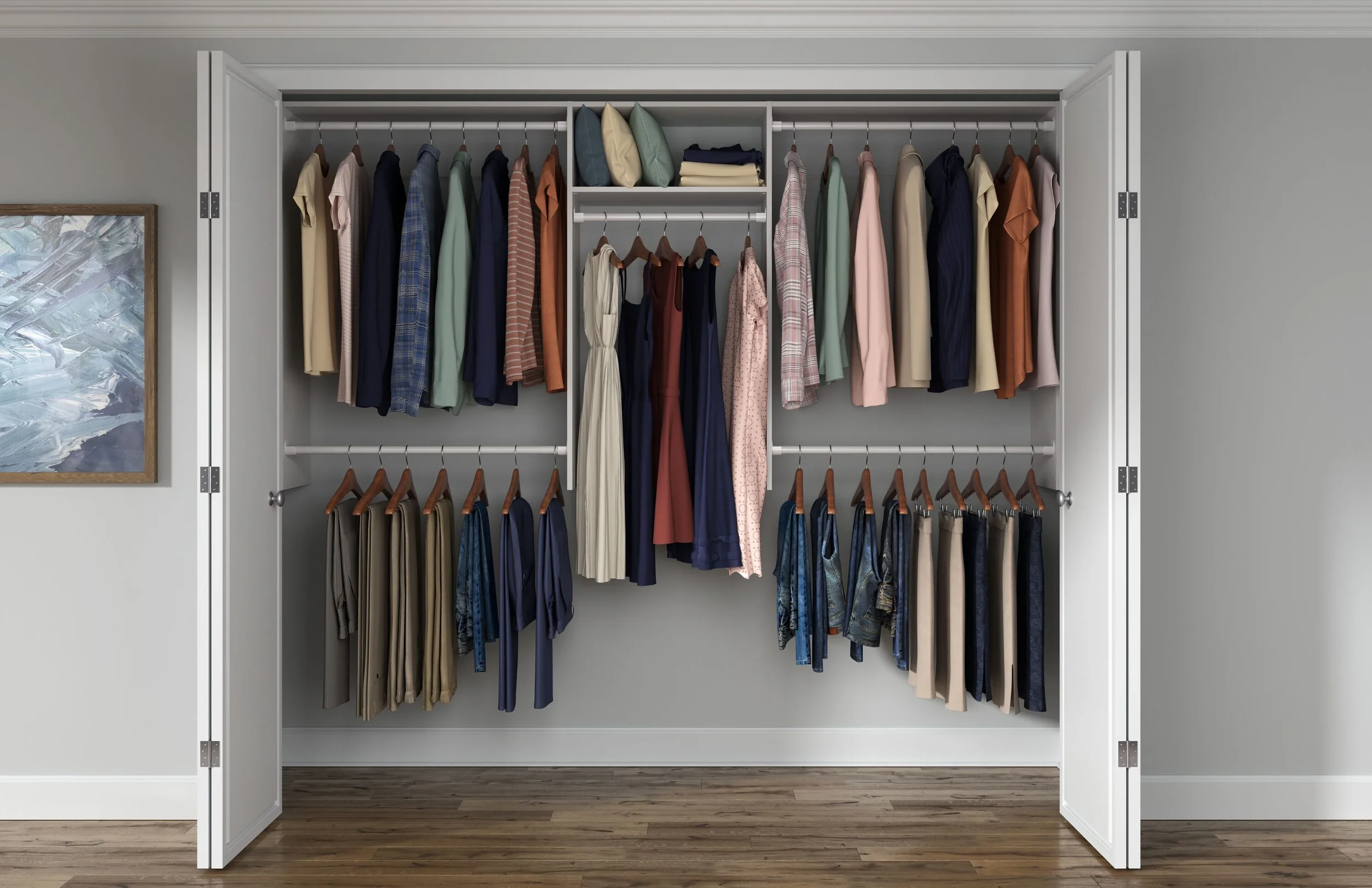Open closet with clothes on hanging rods, organized by type and color, with folded items and pillows on top shelf.
