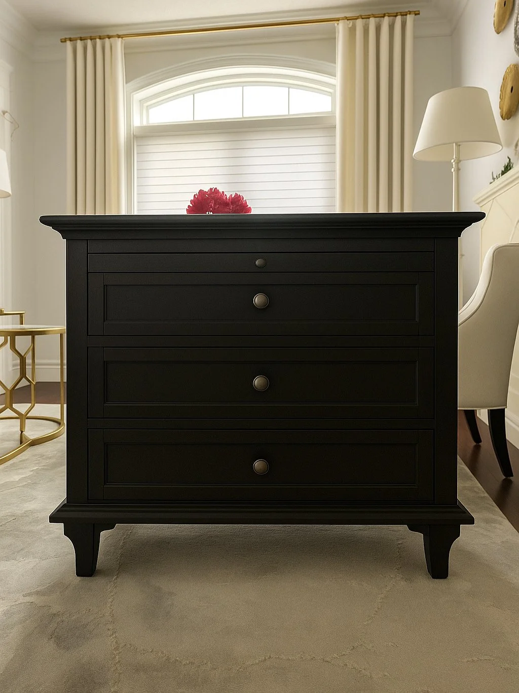 Black dresser with four drawers and round knobs in a bright room with large window and white curtains.