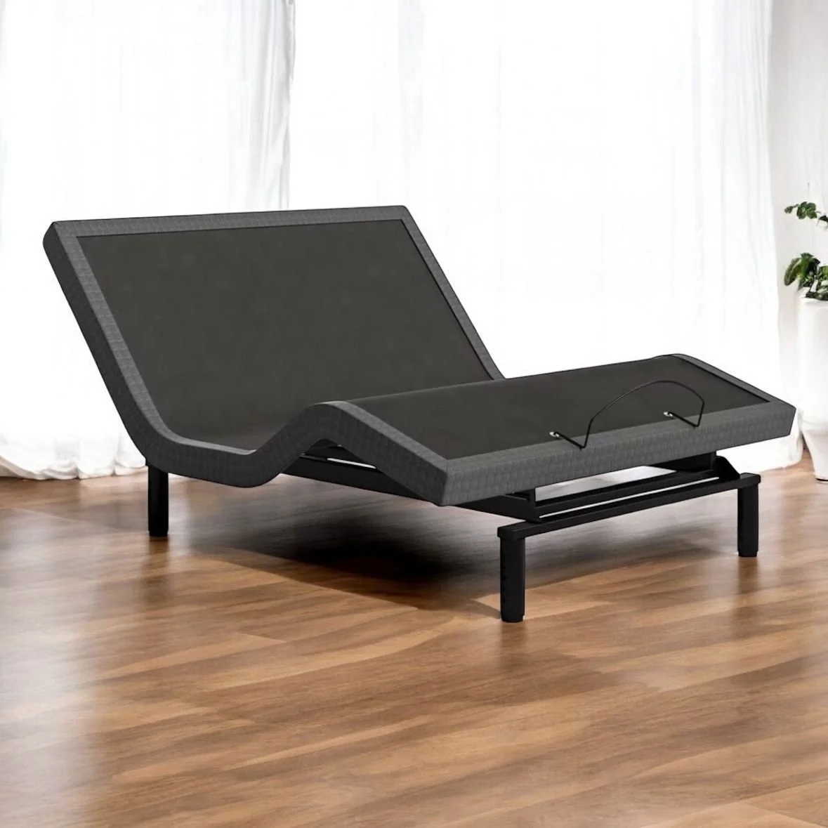 A modern adjustable lounge chair with a black frame and dark grey fabric, positioned on a wooden floor near white curtains and a green potted plant.