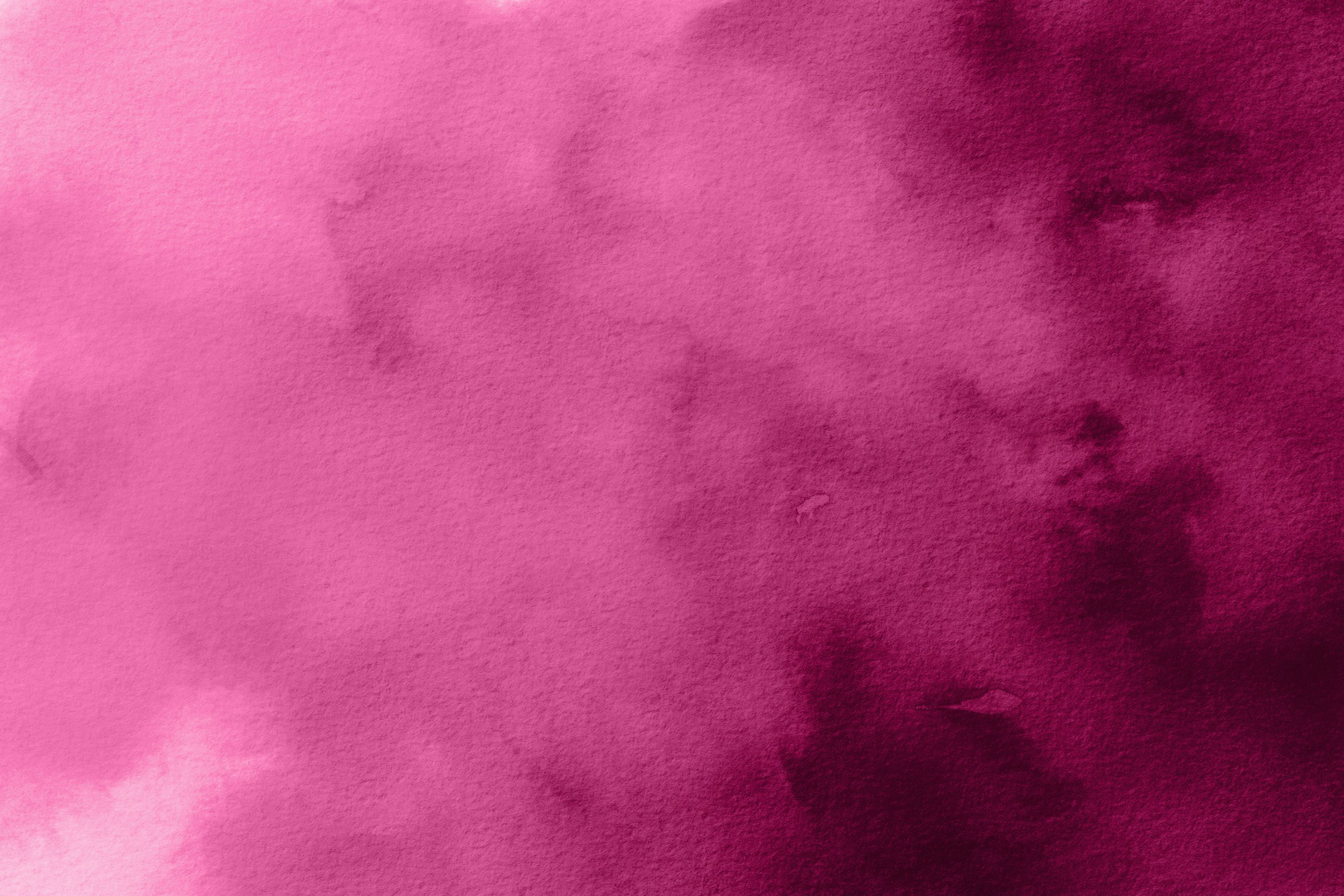 Abstract pink and purple watercolor background with soft blending and varying intensities of color.