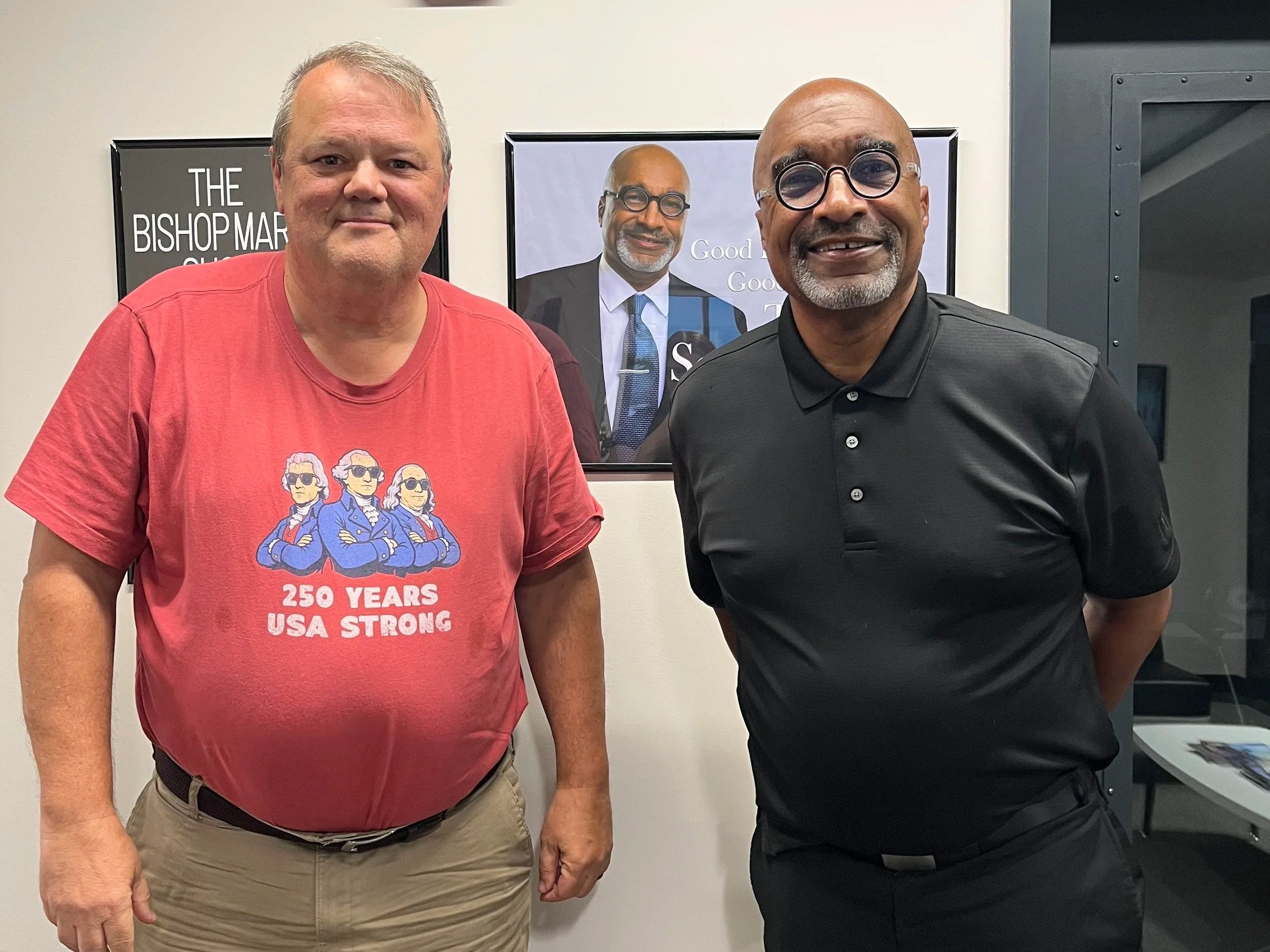 Rob Strickler and Scott Dorsey in front of The Scott Dorsey Show poster.