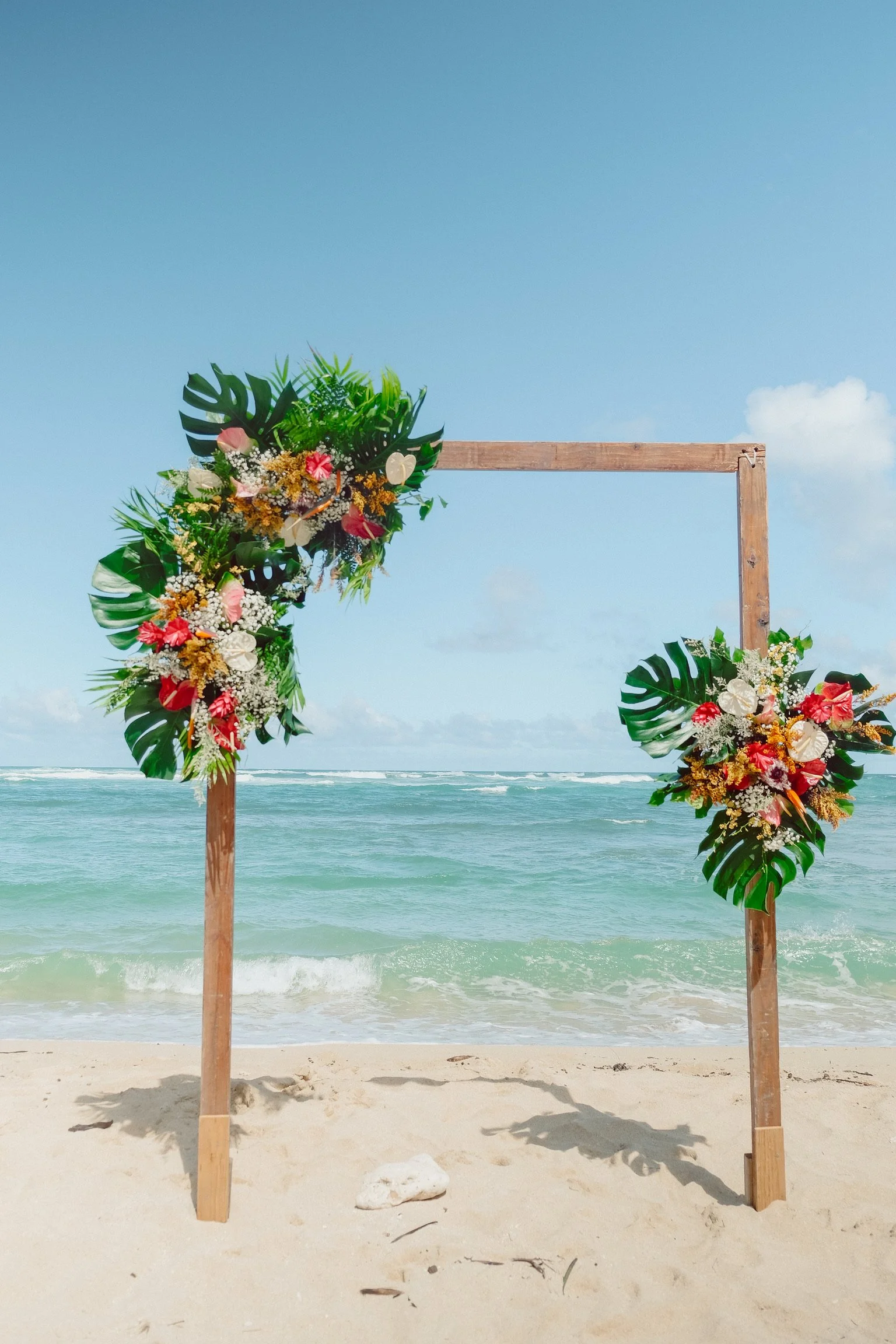 Tropical wedding arch arrangement at Hawaii Polo Club beach ceremony on Oahu