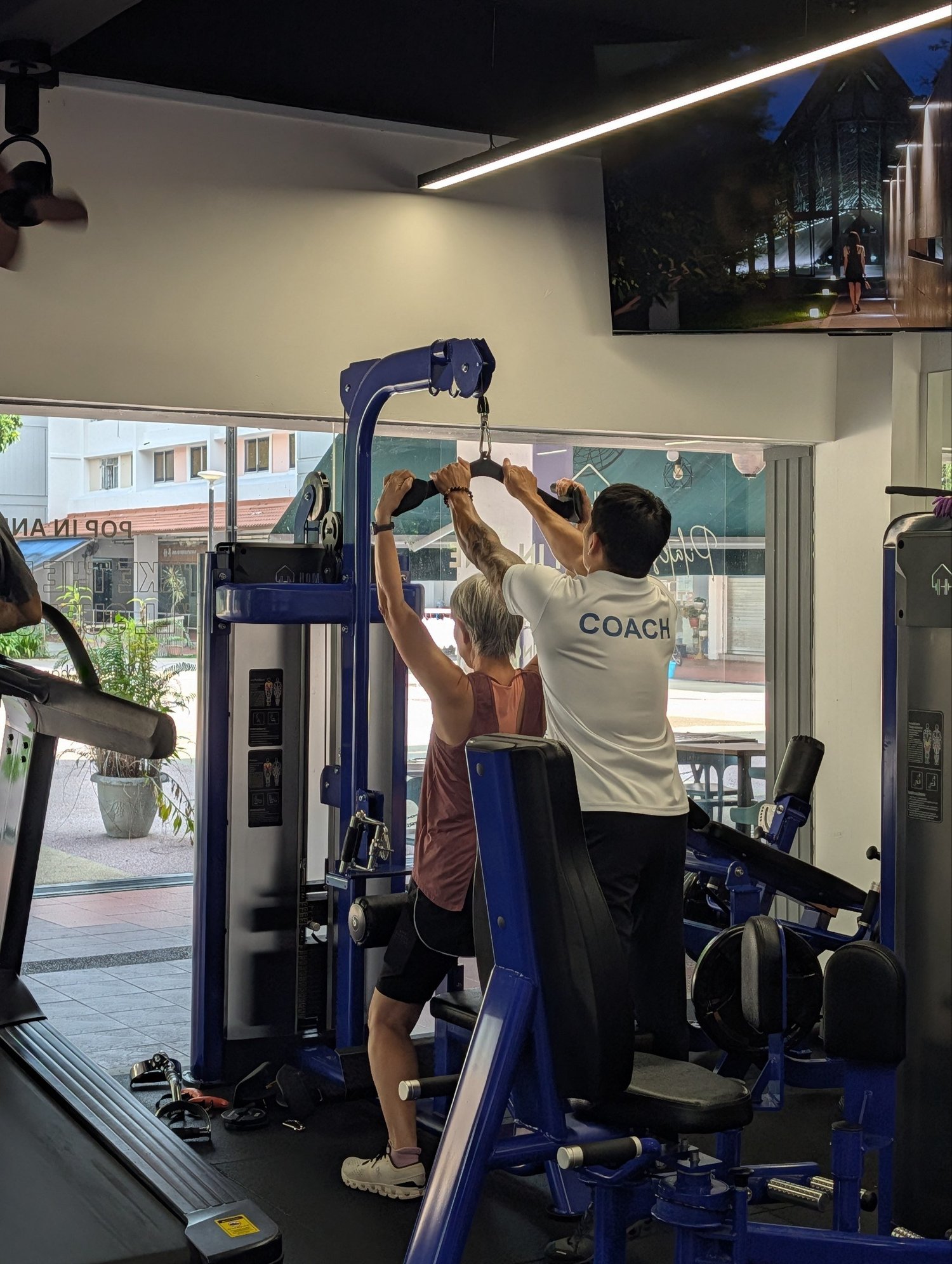 Older woman performing a coached strength exercise