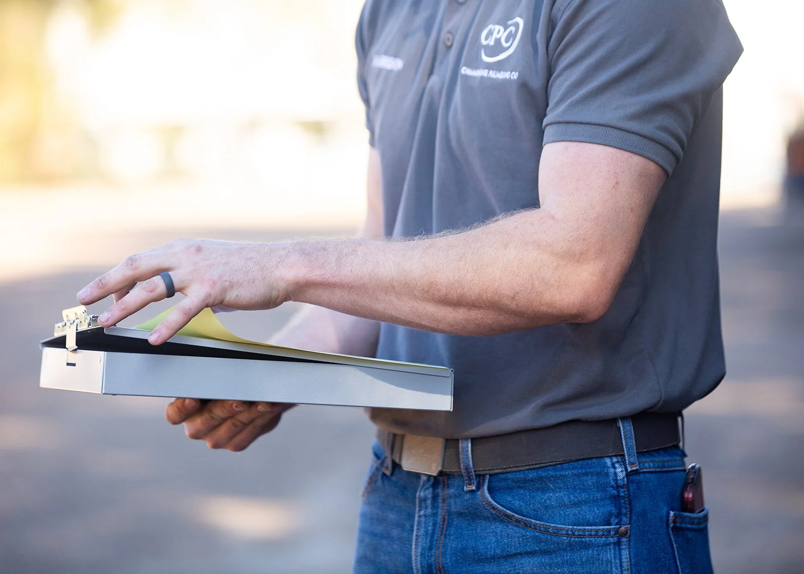 The logo of Champagne Plumbing Co featuring the initials 'CPC' in gray text with a swoosh design, and the company name along with the slogan 'Refined Service. Reliable Results.' in gold and gray text on a black background.