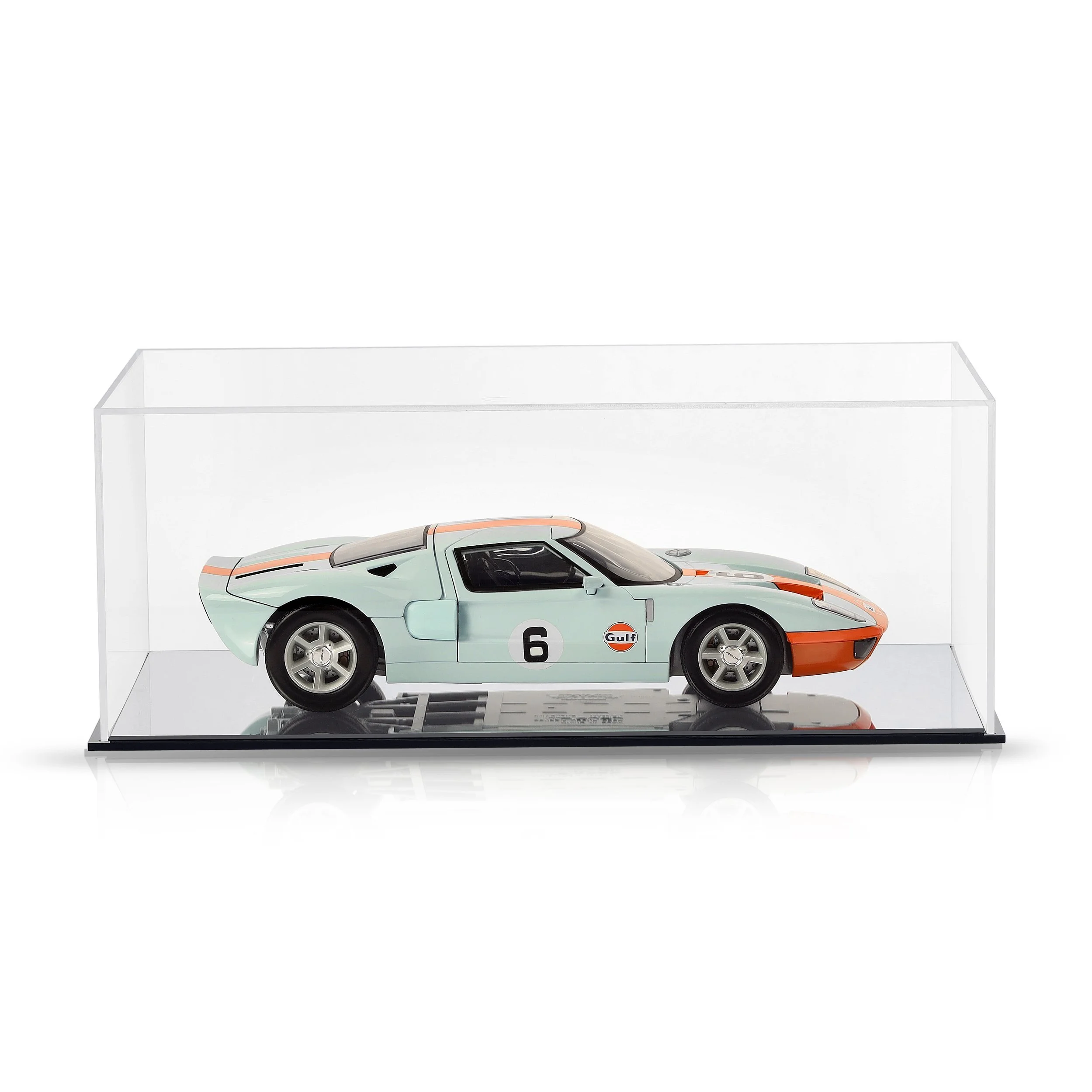 Miniature model of a vintage race car displayed in a clear glass case on a white background.