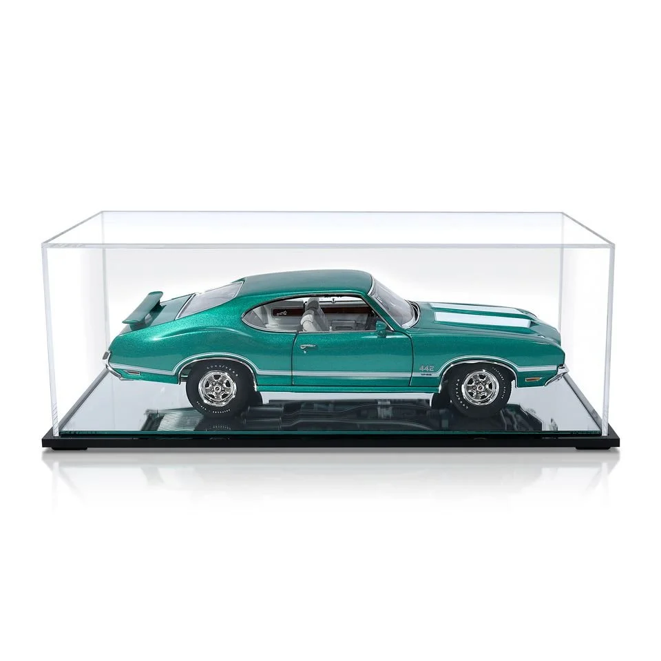 A model of a vintage green muscle car inside a clear display case.