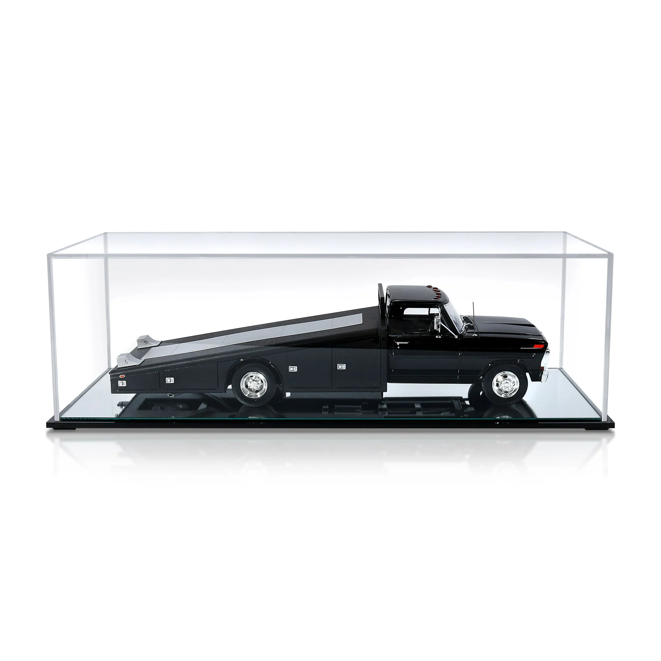 Scale model of a black tow truck inside a clear display case.