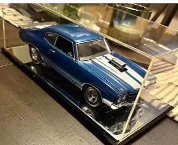 Blue vintage muscle car model displayed inside a glass case.