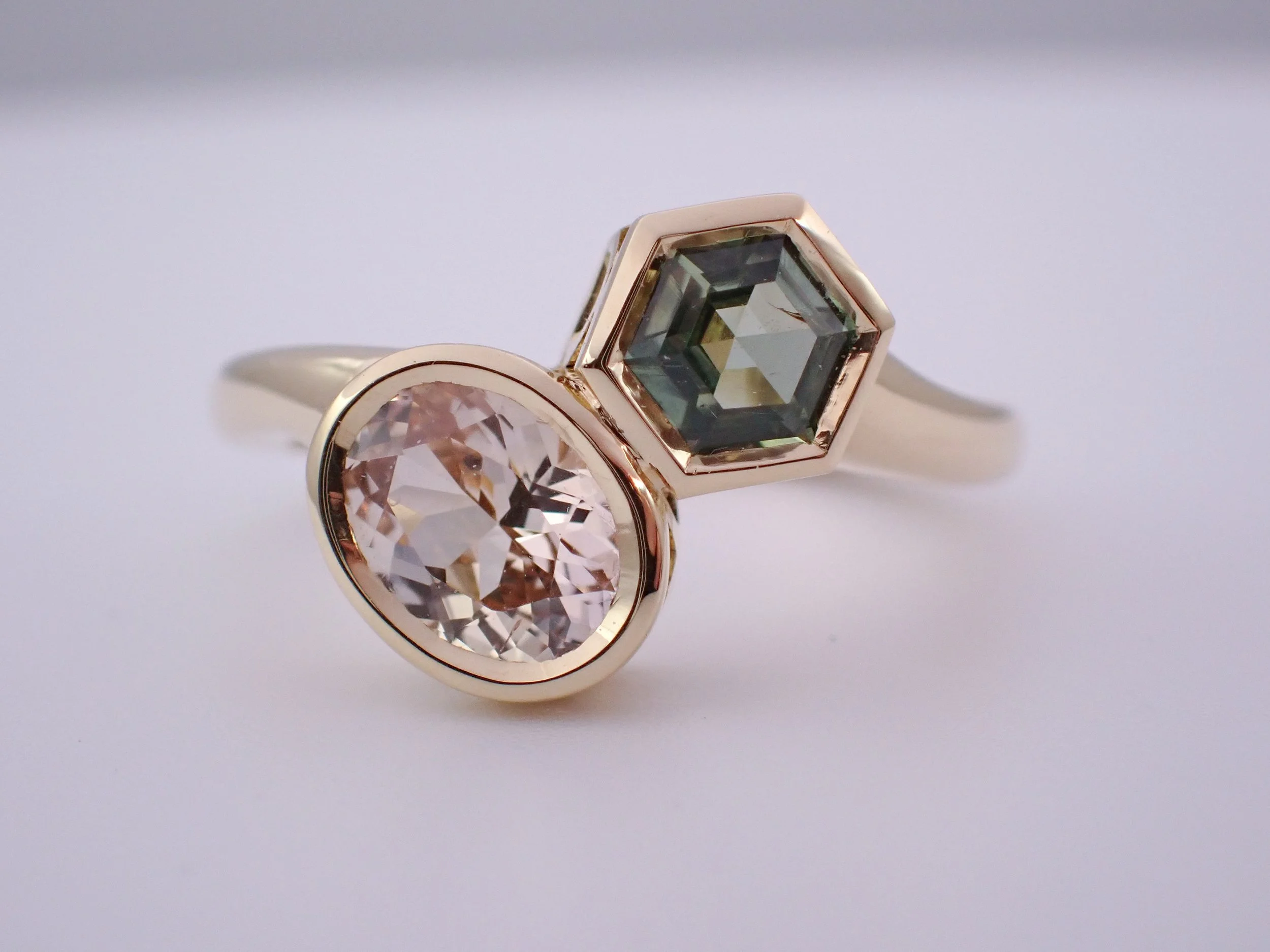 Peach + green sapphire toi et moi engagement ring.jpg