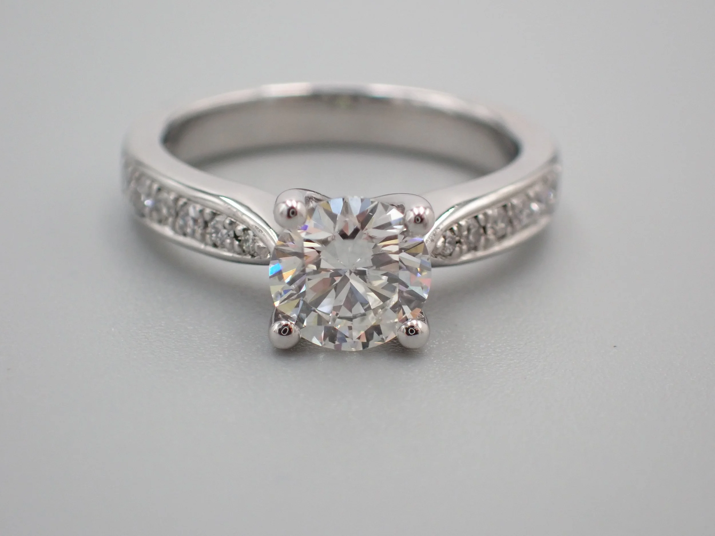 Diamond set engagement ring with diamond set shoulders.jpg