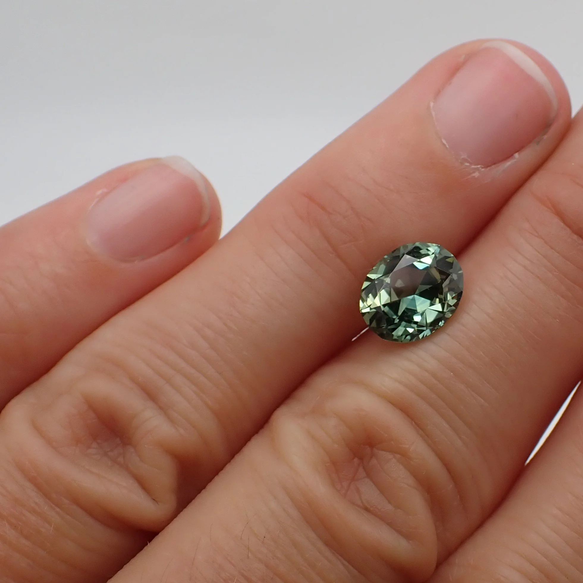 australian-light-teal-sapphire-oval-cut-2.44ct-scale.JPG