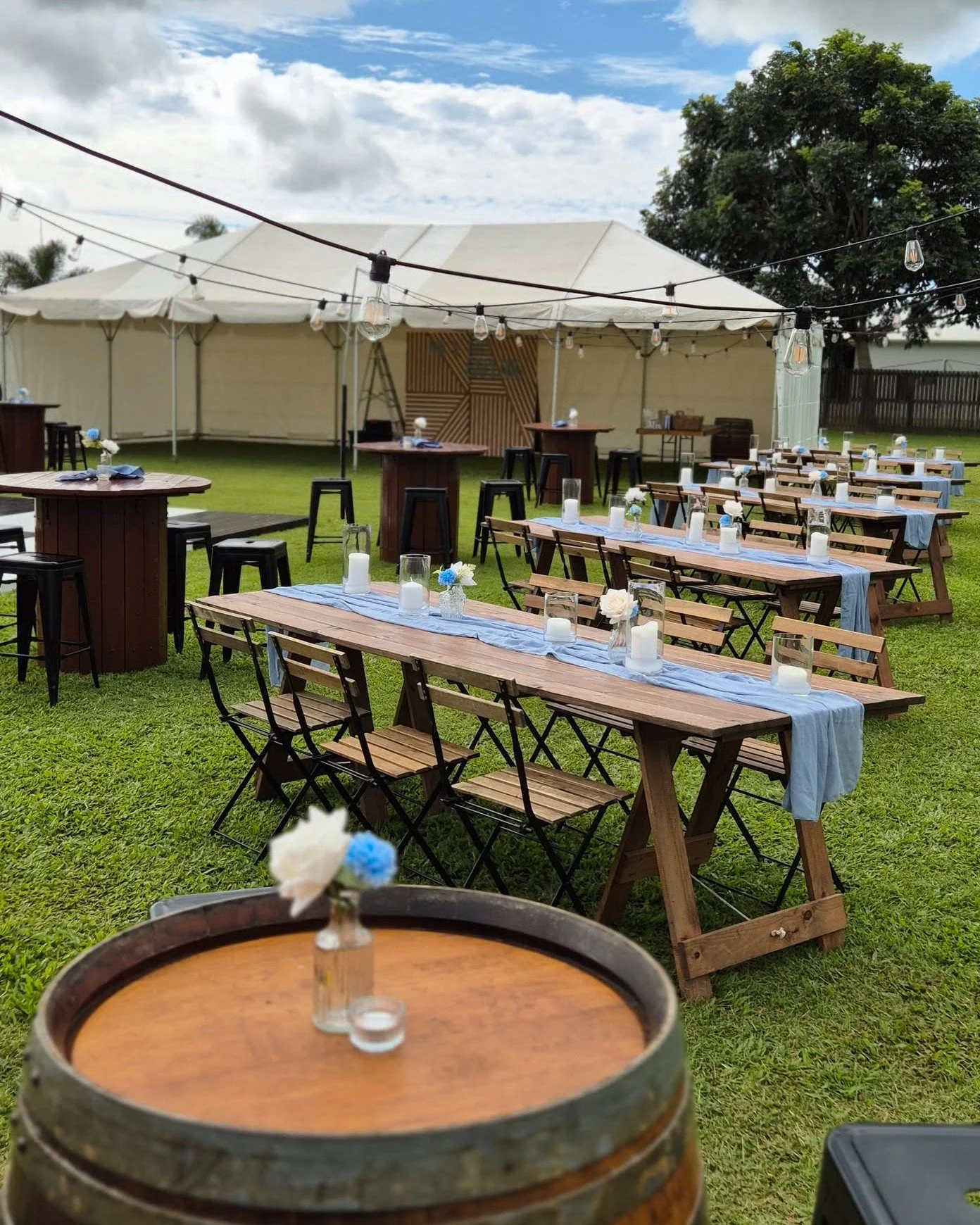 Dining under the stars. ✨

Taylor &amp; Anthony's outdoor reception was the epitome of relaxed elegance. Long rustic timber tables, soft blue runners, and festoon lighting created an intimate, family-style dining experience as the sun went down.

The