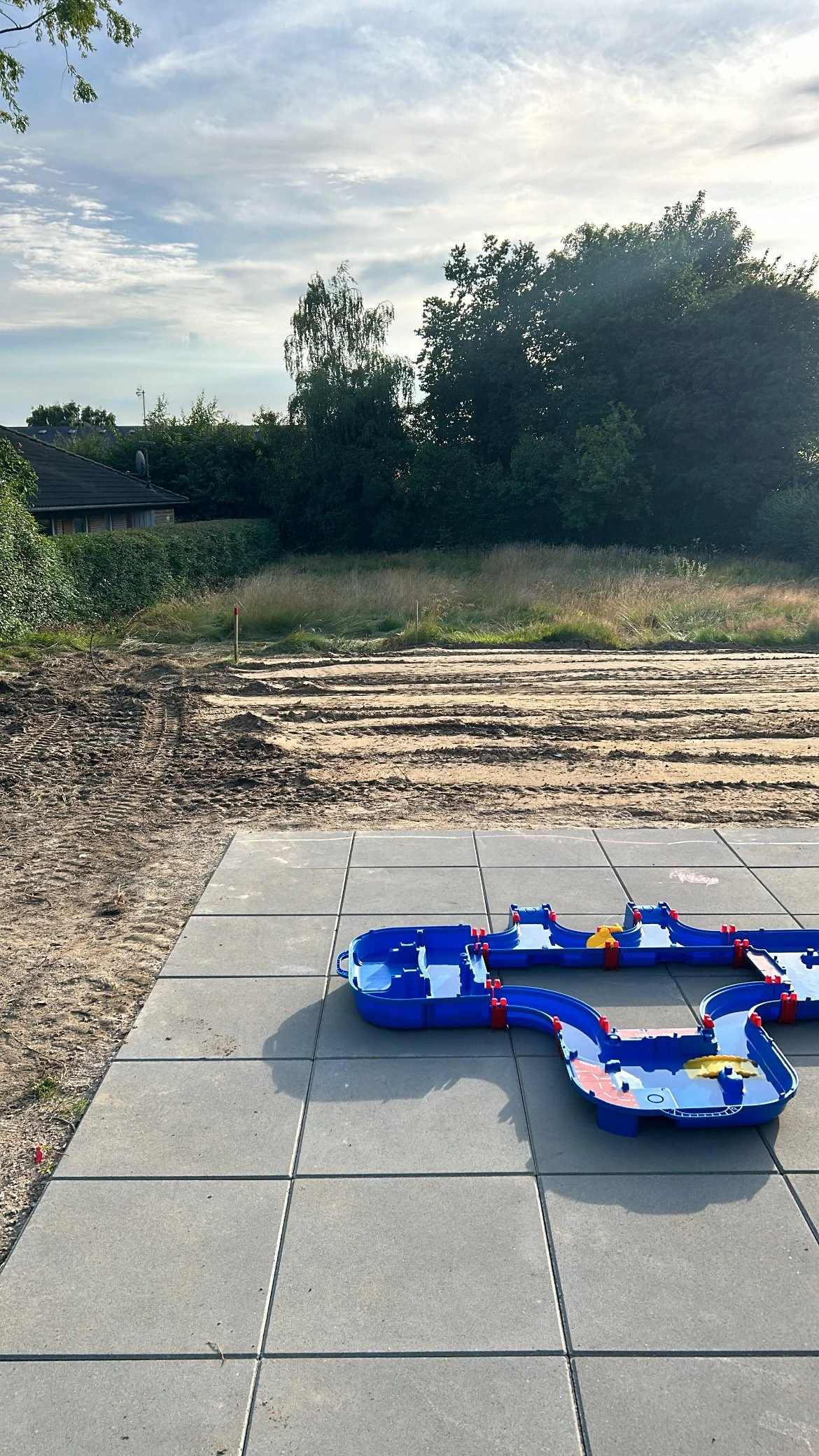 Before and after transformation of a newbuild garden, showing how an unfinished outdoor space can be turned into a calm, functional garden in just one season.