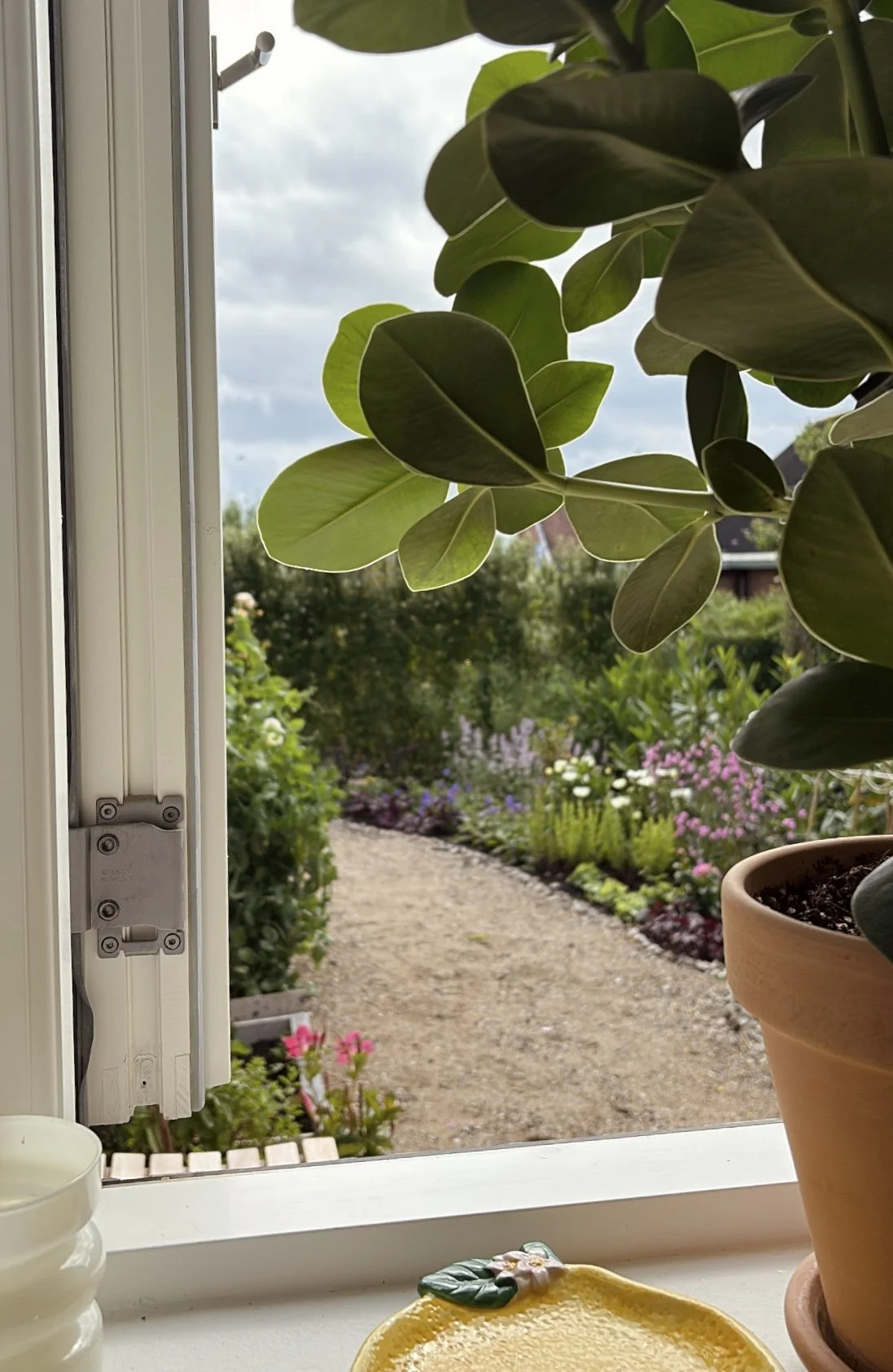 Before and after transformation of a newbuild garden, showing how an unfinished outdoor space can be turned into a calm, functional garden in just one season.
