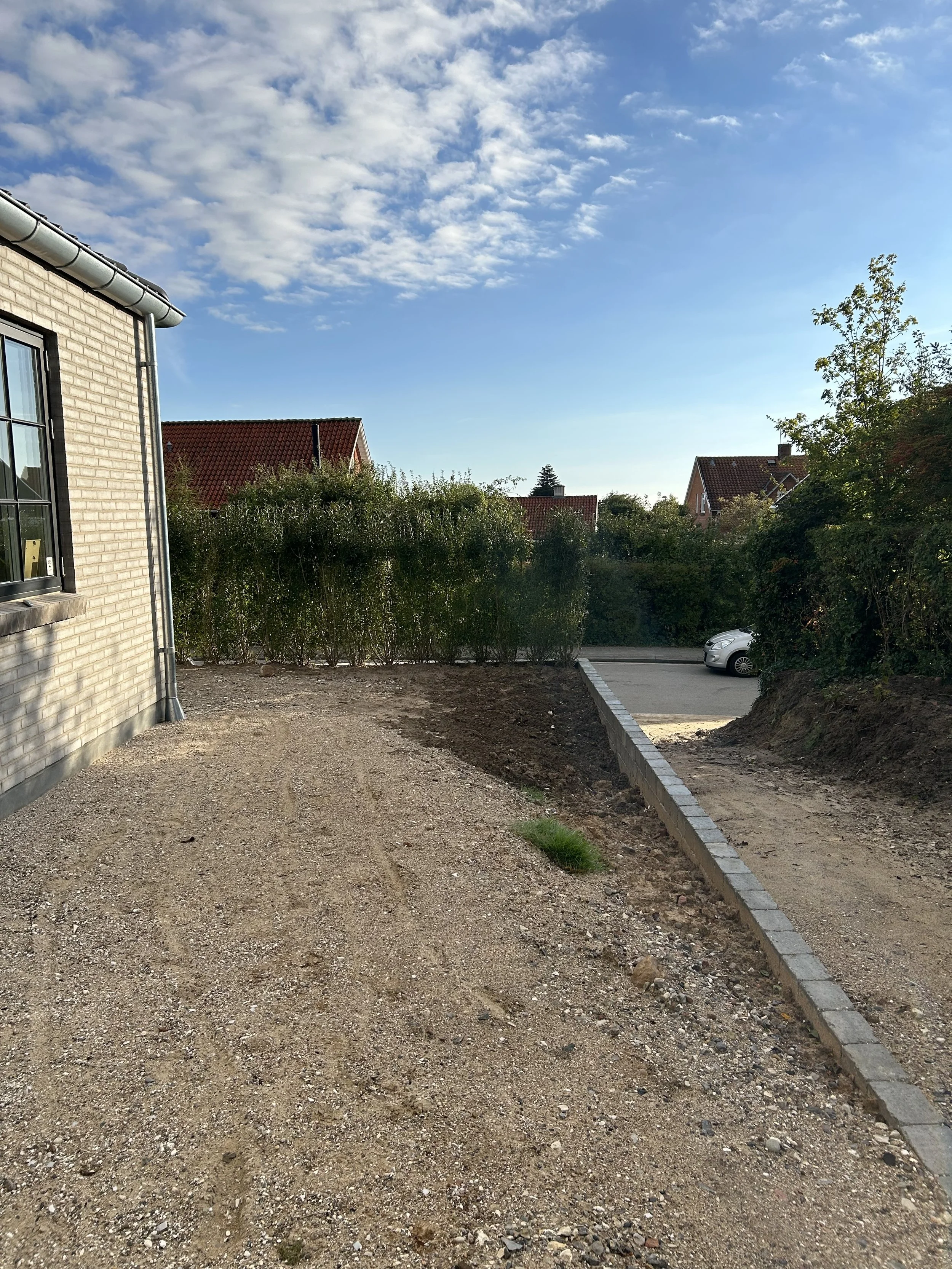 Before and after transformation of a newbuild garden, showing how an unfinished outdoor space can be turned into a calm, functional garden in just one season.