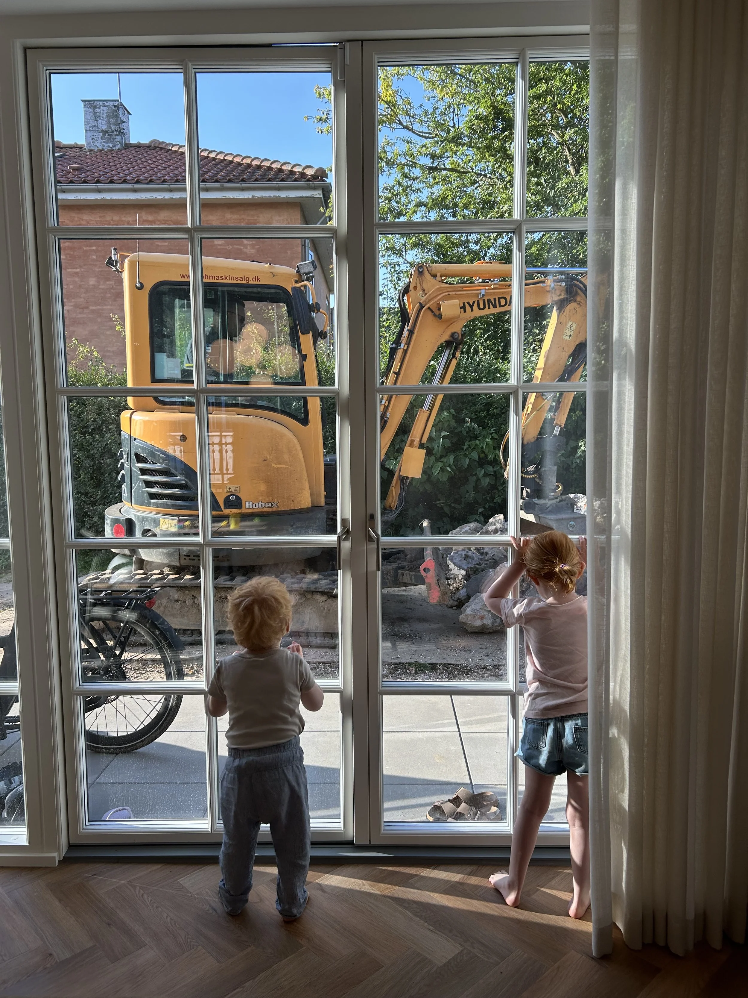 Before and after transformation of a newbuild garden, showing how an unfinished outdoor space can be turned into a calm, functional garden in just one season.