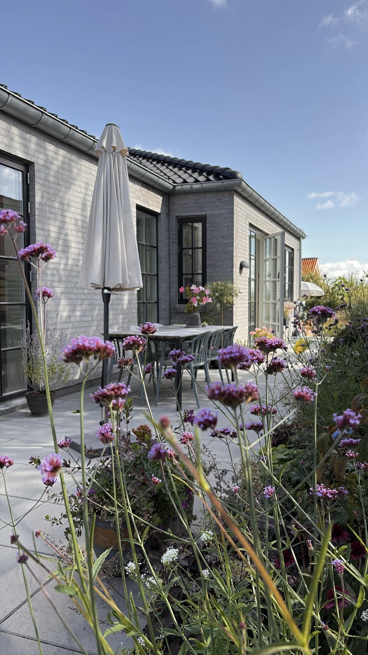 Before and after transformation of a newbuild garden, showing how an unfinished outdoor space can be turned into a calm, functional garden in just one season.
