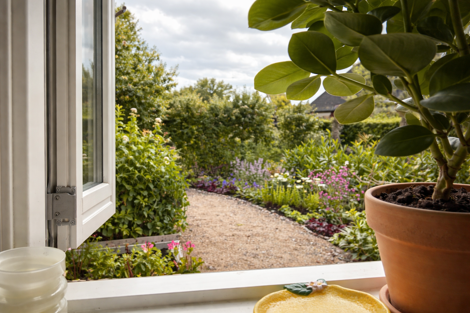Before and after transformation of a newbuild garden, showing how an unfinished outdoor space can be turned into a calm, functional garden in just one season.