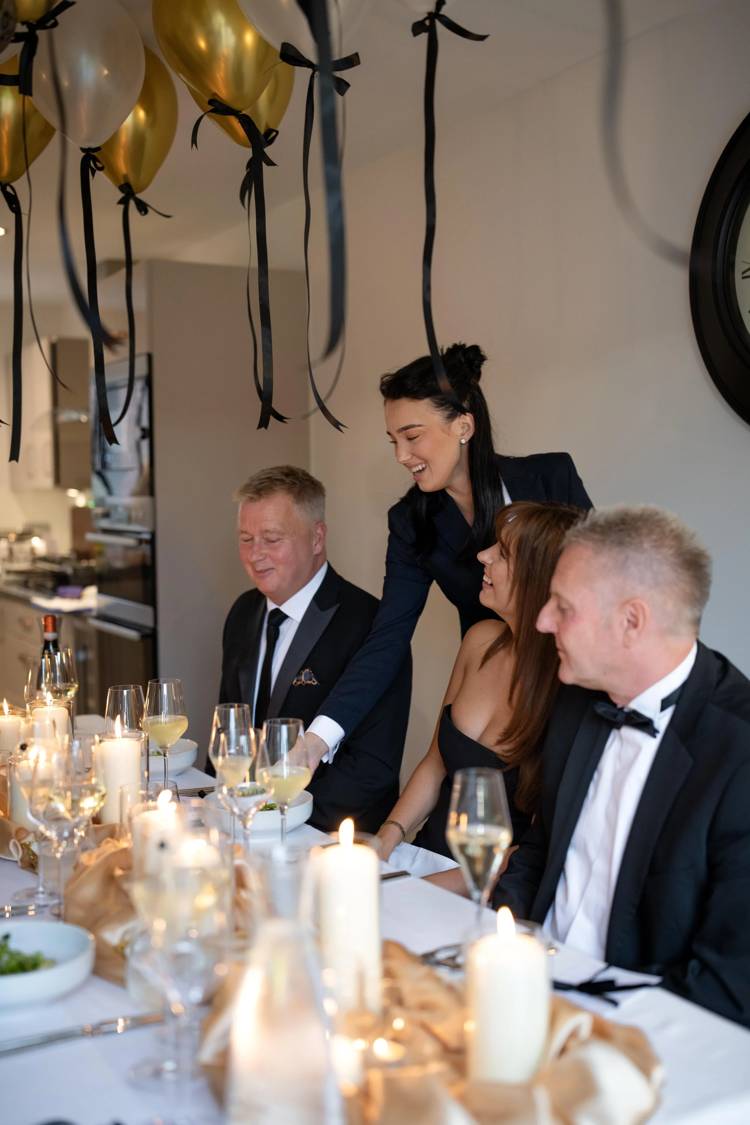 People having a dinner party with balloons and candles