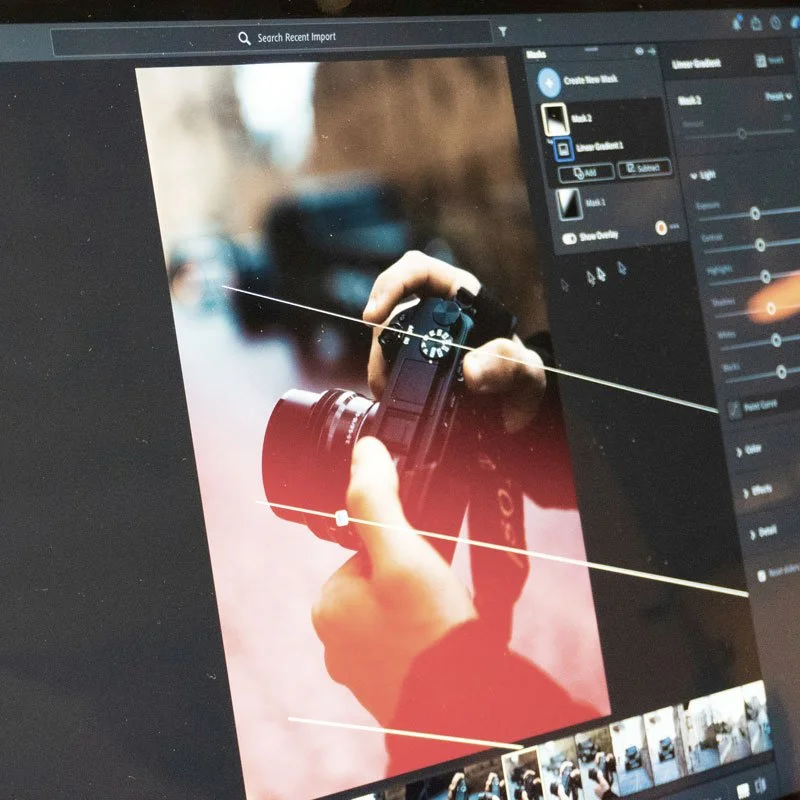 Photographer reviewing and editing images on a computer for approval