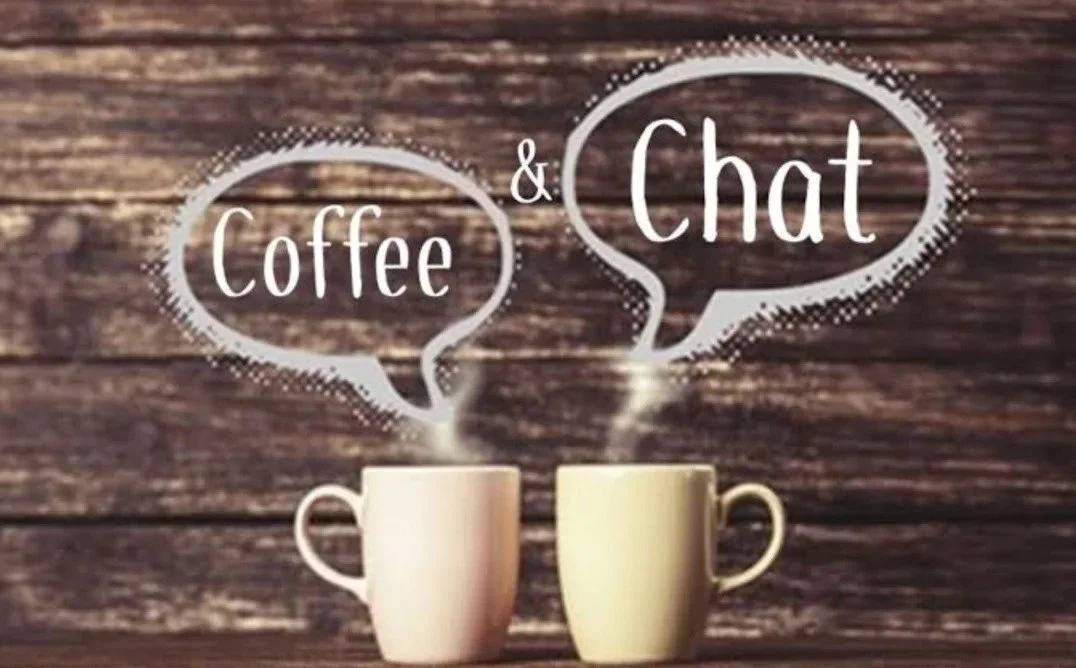 Two coffee mugs on a wooden surface with steam-shaped speech bubbles above them. The bubble on the left reads 'Coffee' and the one on the right reads 'Chat'.