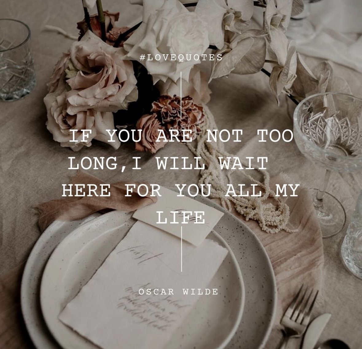 A table setting with a bouquet of dried flowers, empty glasses, and a plate with a handwritten letter, overlaid with a quote by Oscar Wilde about waiting for loved ones.