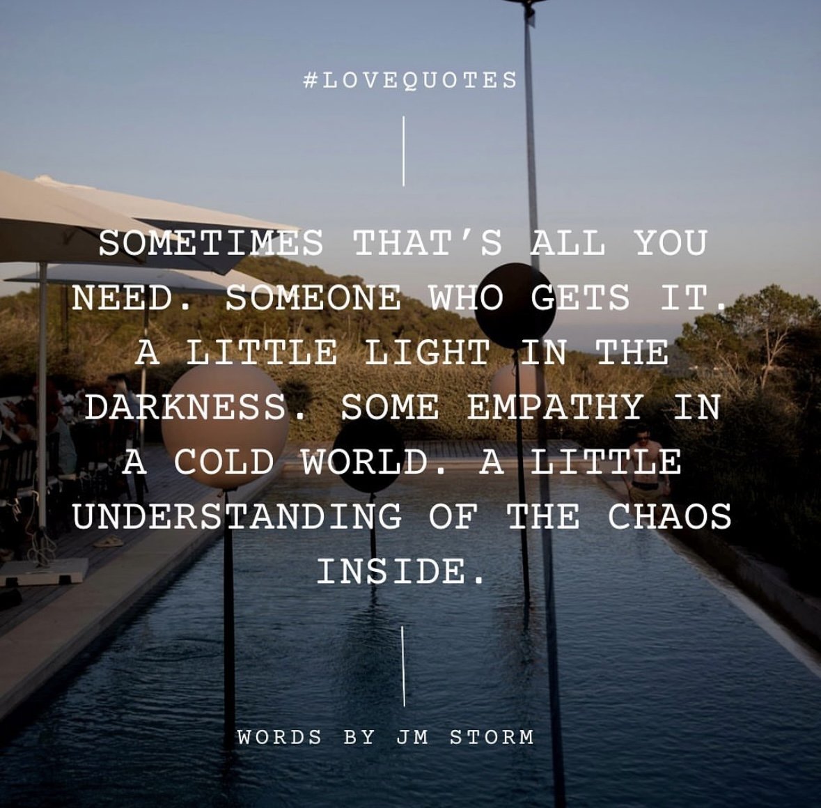 A poolside scene with floating lanterns and an outdoor umbrella at sunset, overlaid with a quote about love, compassion, and understanding.