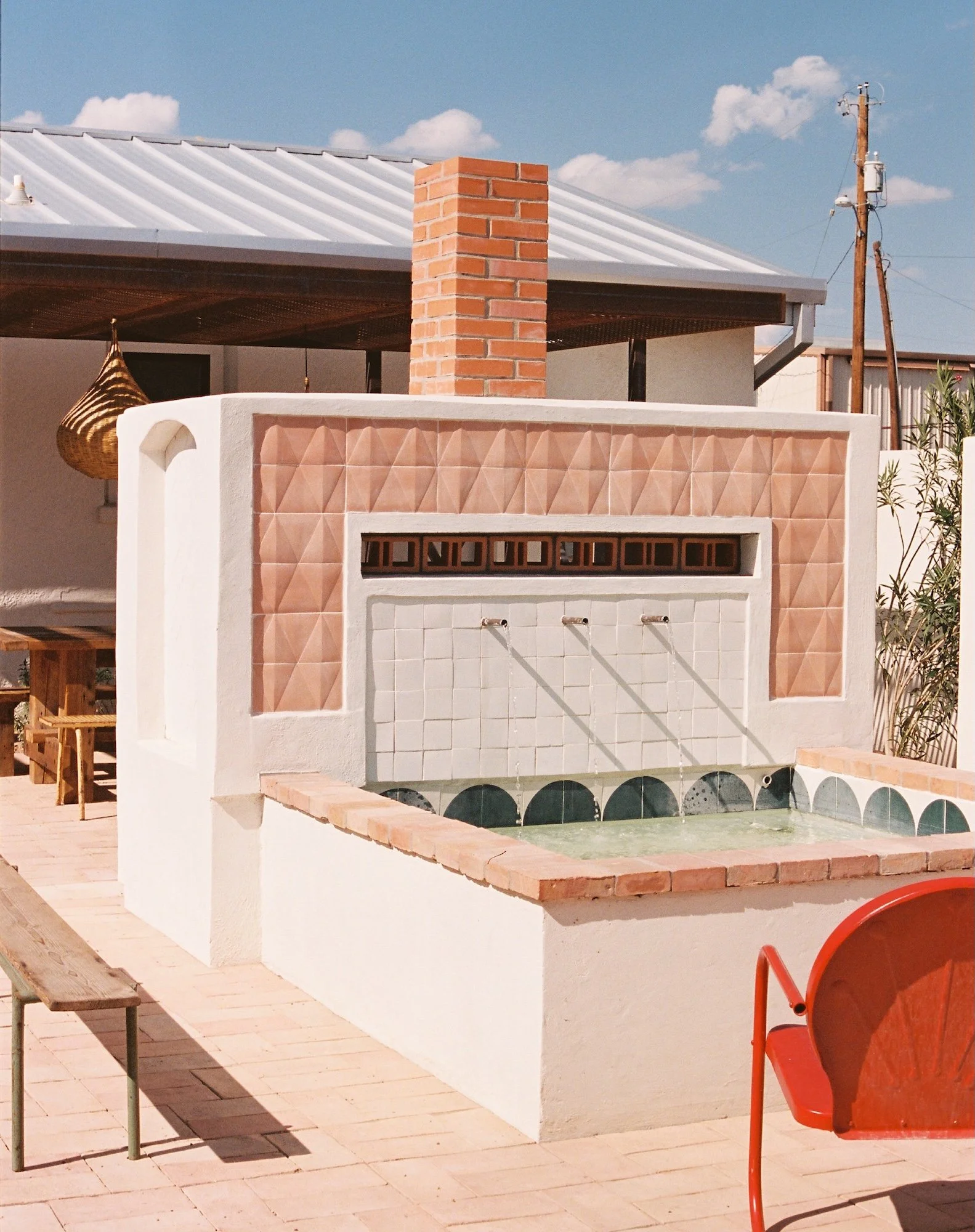 Commonwealth-Interior-Design-Austin-Texas-Motel-Outdoor-Fireplace-With-Water-Feature.jpg