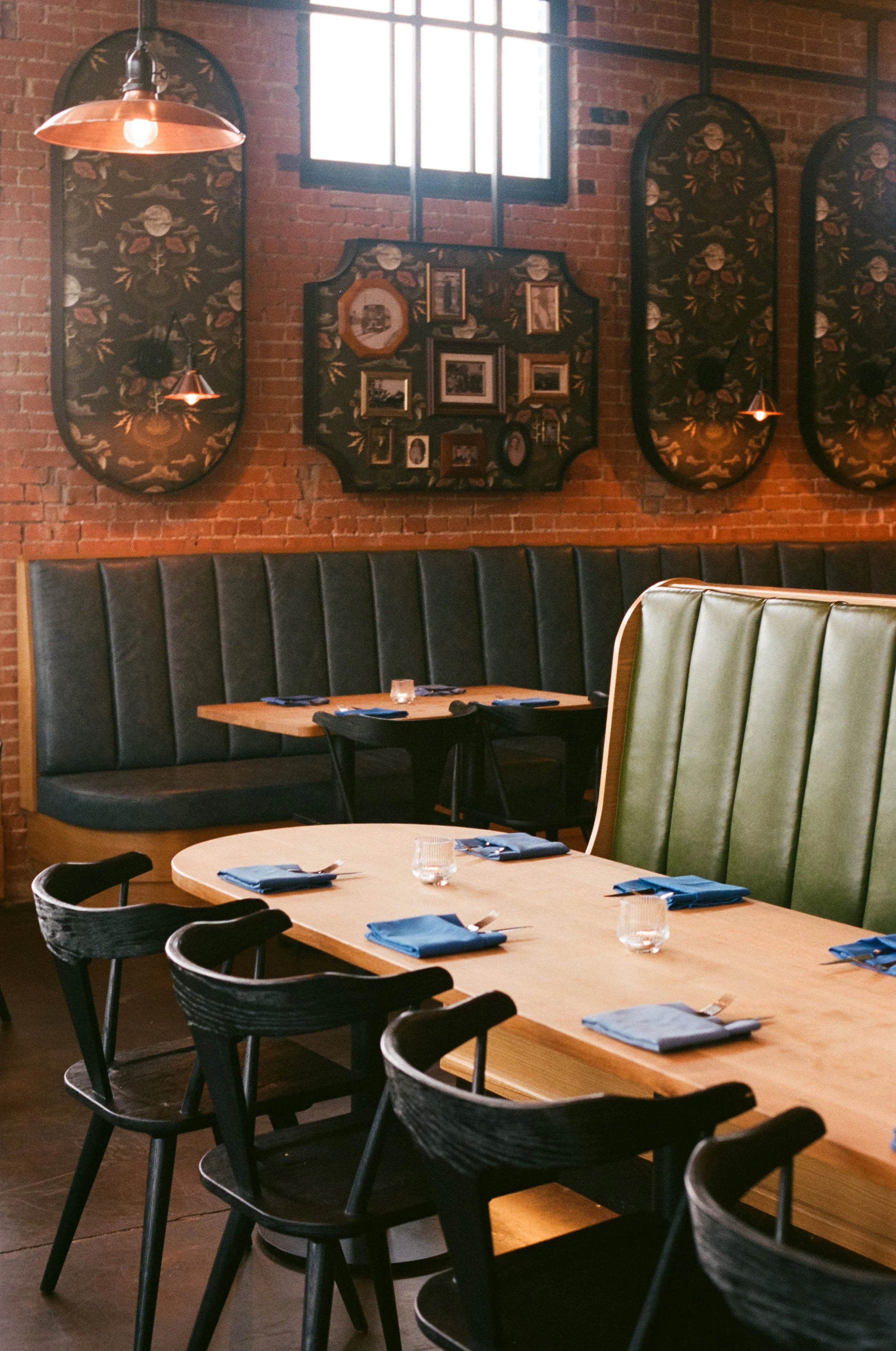 Restaurant interior, showing banquette seating and patterned wall panels.