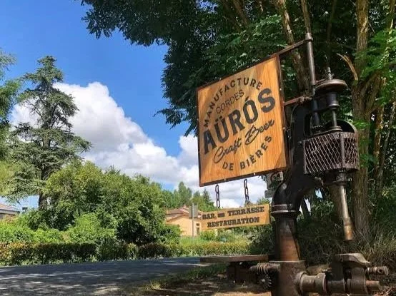 Sign for Aurous Brewery, craft beer, beer and terrace restaurant, with trees and blue sky in the background