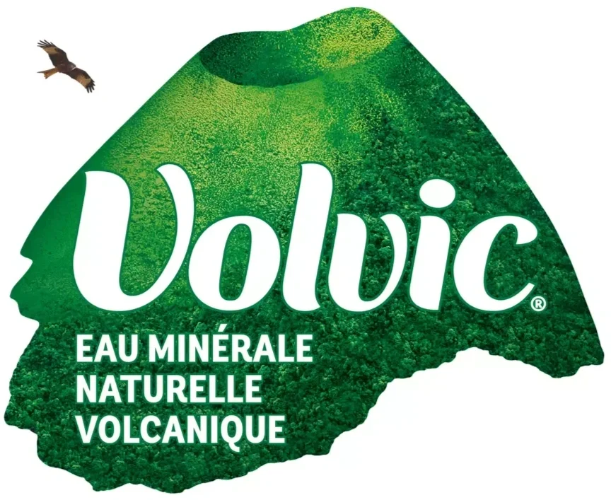 A green mountain-shaped illustration with the word "Volvic" in large white letters, along with the text "Eau Minérale Naturelle Volcanique" and a flying bird in the top left corner.