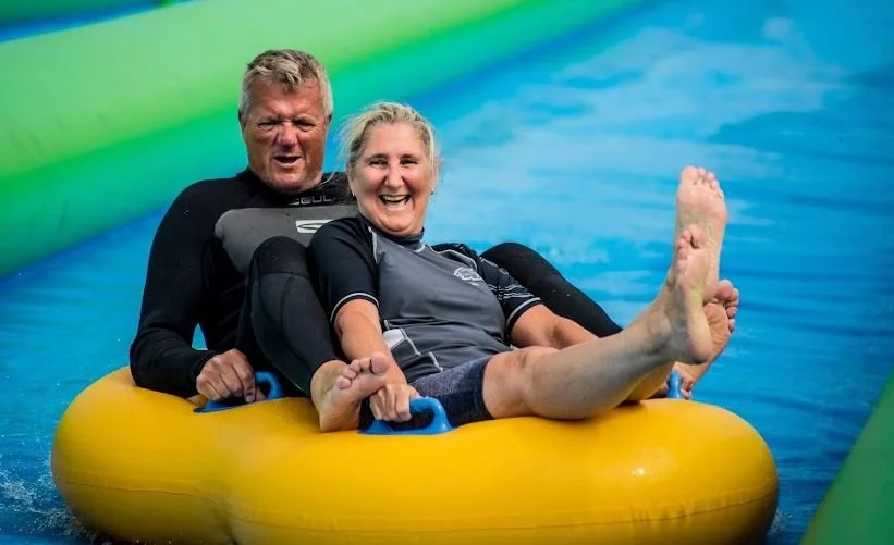 Couple enjoying the Giant slide and slide park in Cornwall