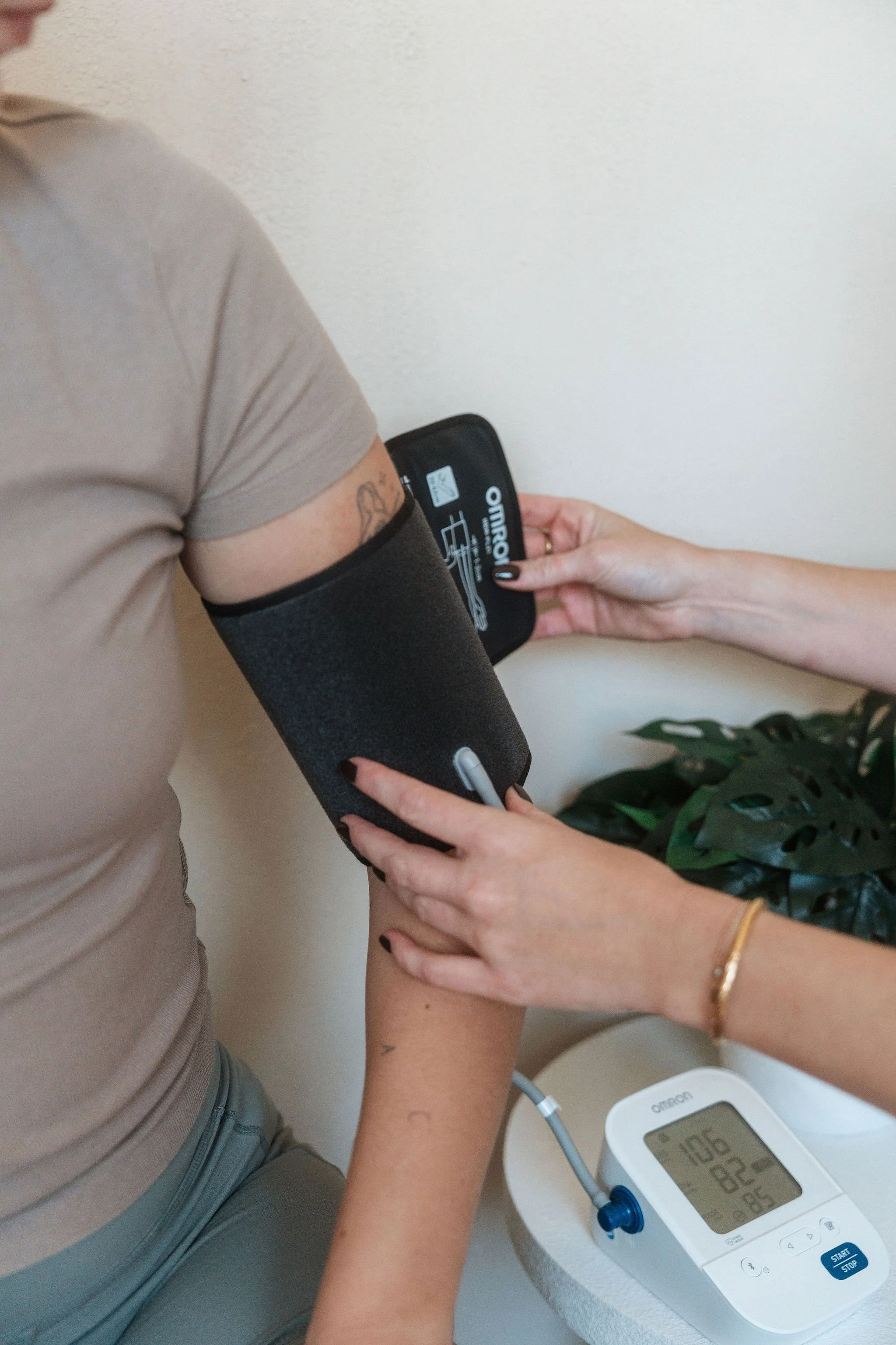 Close-up of blood pressure cuff on a client's arm during an exercise physiology consultation at CardioCare Clinic, Bondi Junction