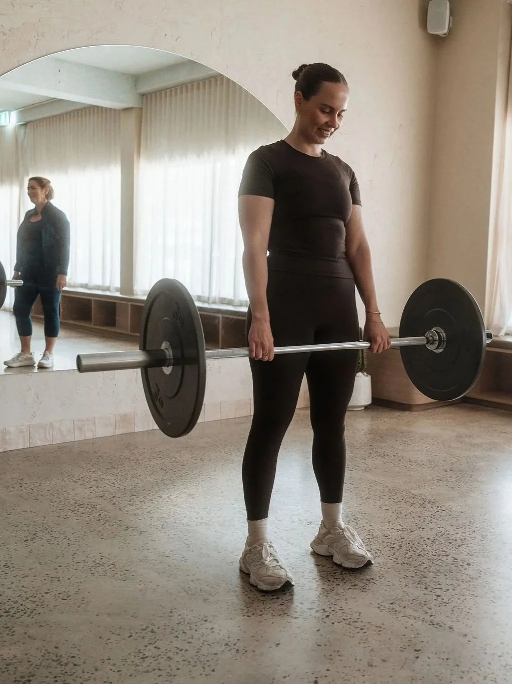 Exercise physiologist demonstrating a deadlift to a client at CardioCare Clinic, Bondi Junction