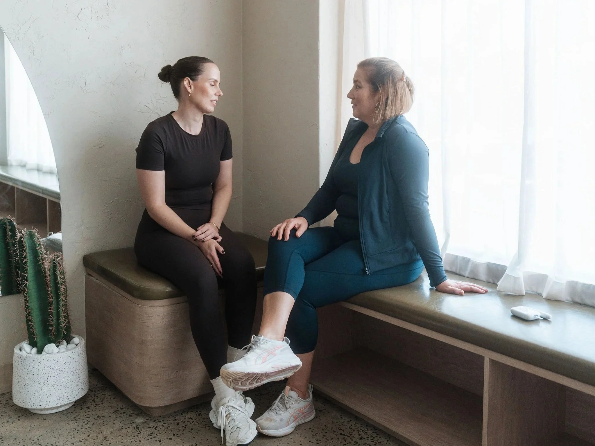 Exercise physiologist talking with a client about ongoing care after cardiac rehab at CardioCare Clinic, Bondi Junction