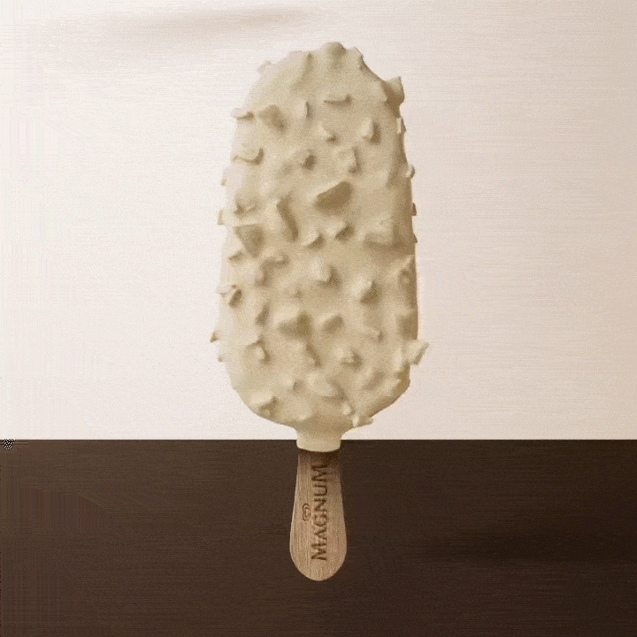 Ice cream bar coated with white chocolate and crunchy toppings on a wooden stick.
