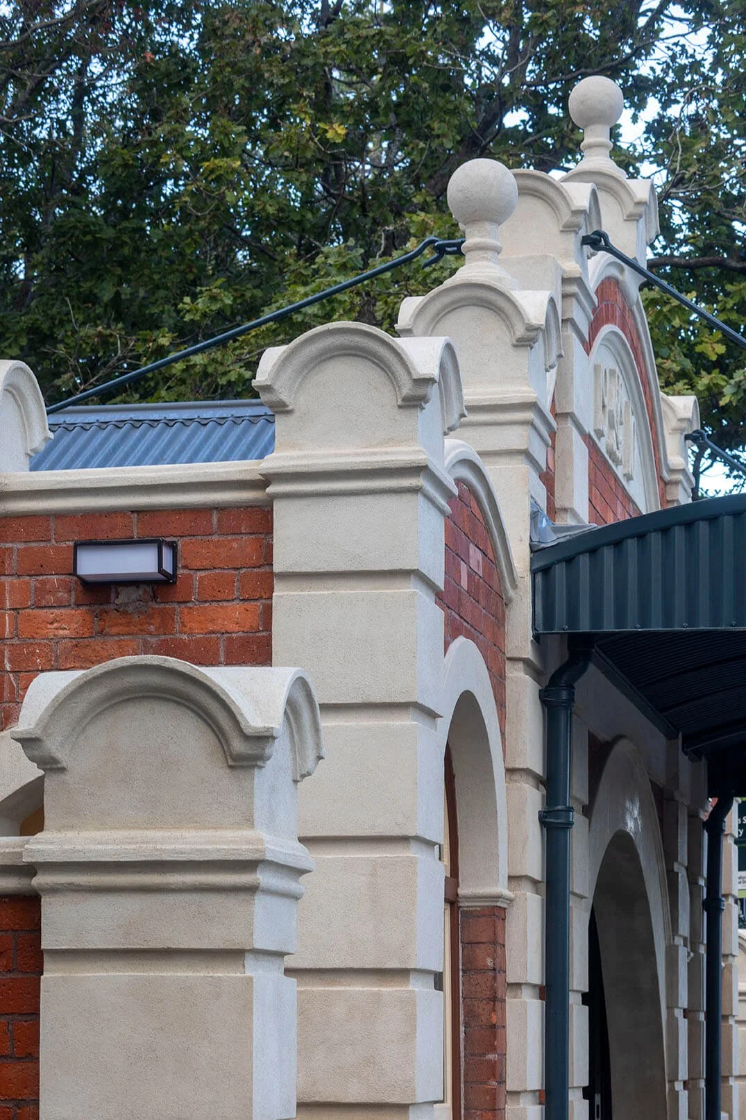 Andrew Plastering detailed plaster restoration on heritage facade of Grafton Bridge Toilets Auckland.
