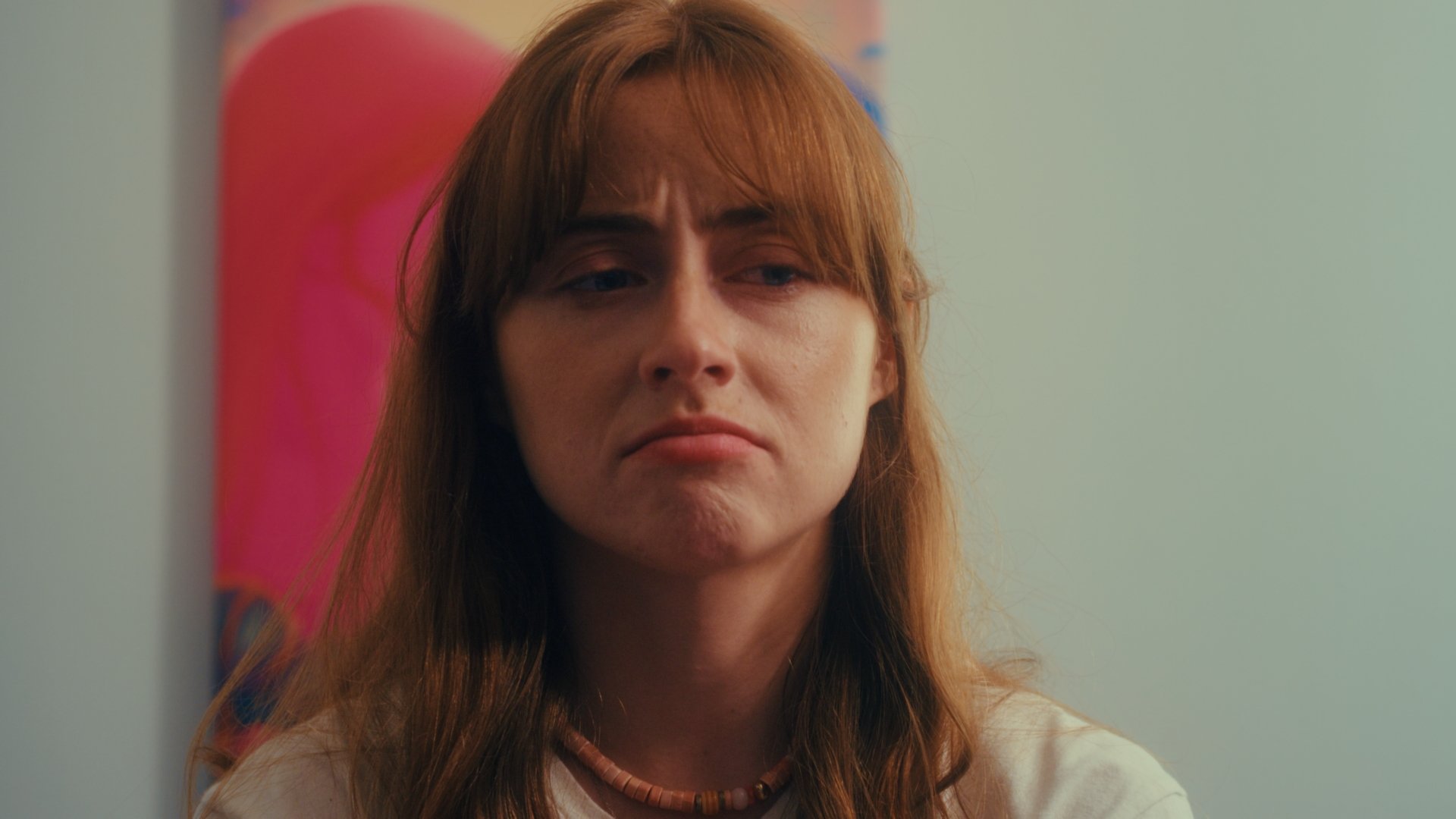 Woman stares into space with confusion.