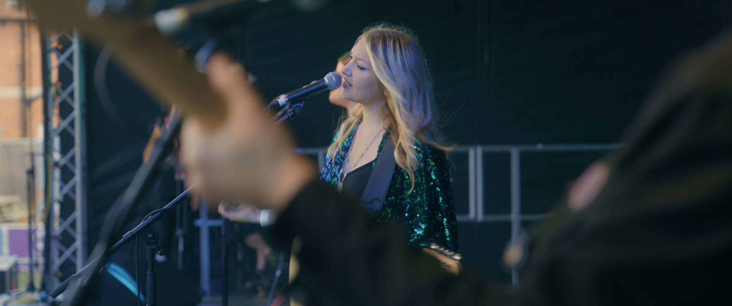 A woman performs on a music stage.