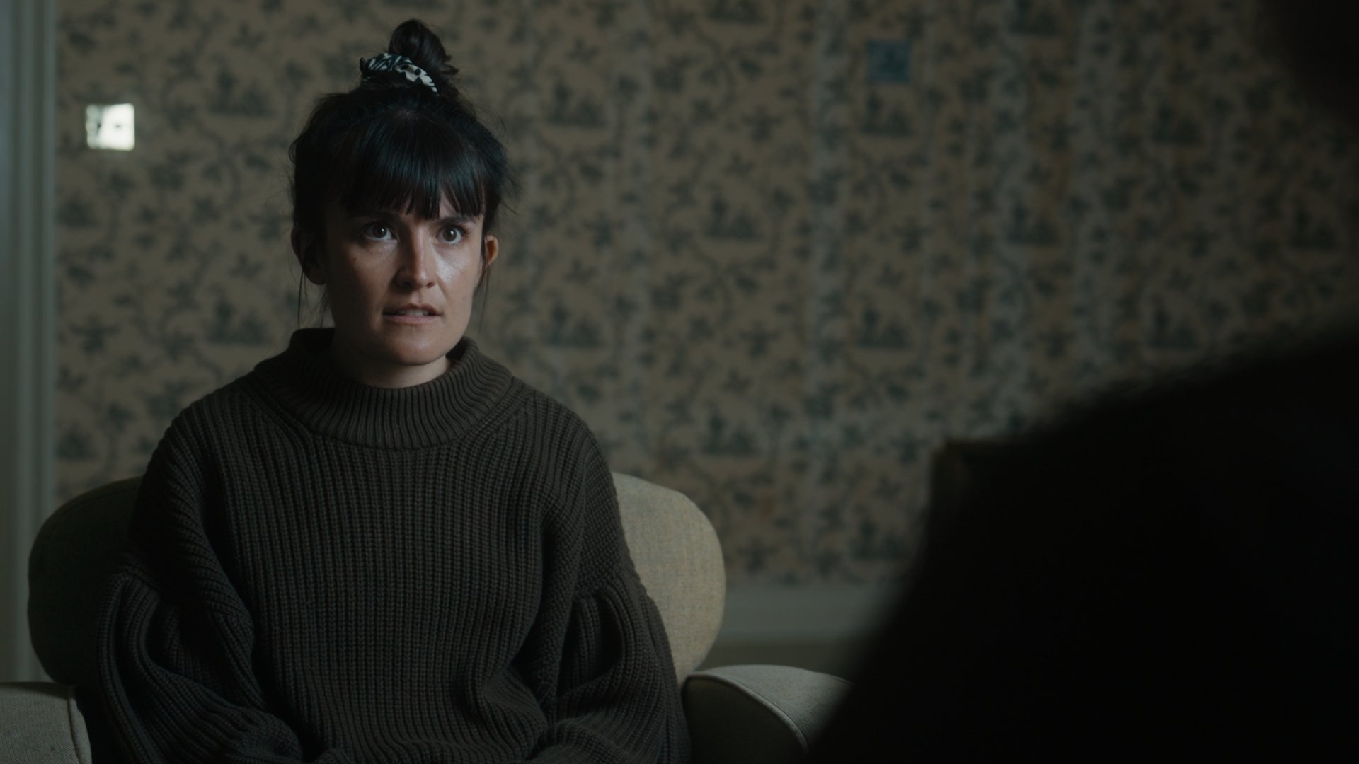 A woman looks annoyed at someone.
