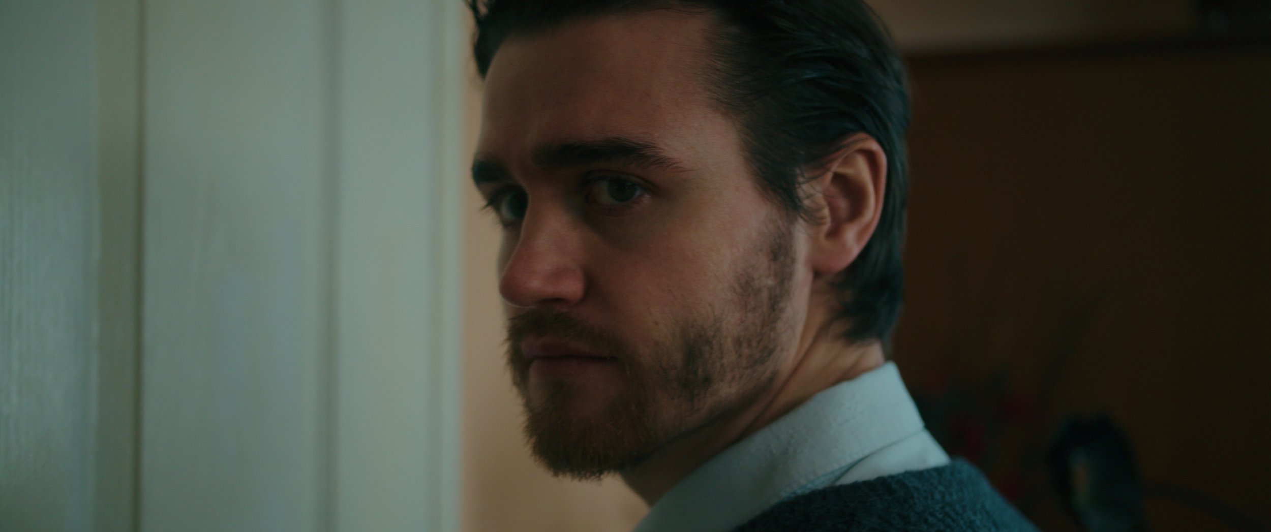 Closeup shot of a man looking to the side.