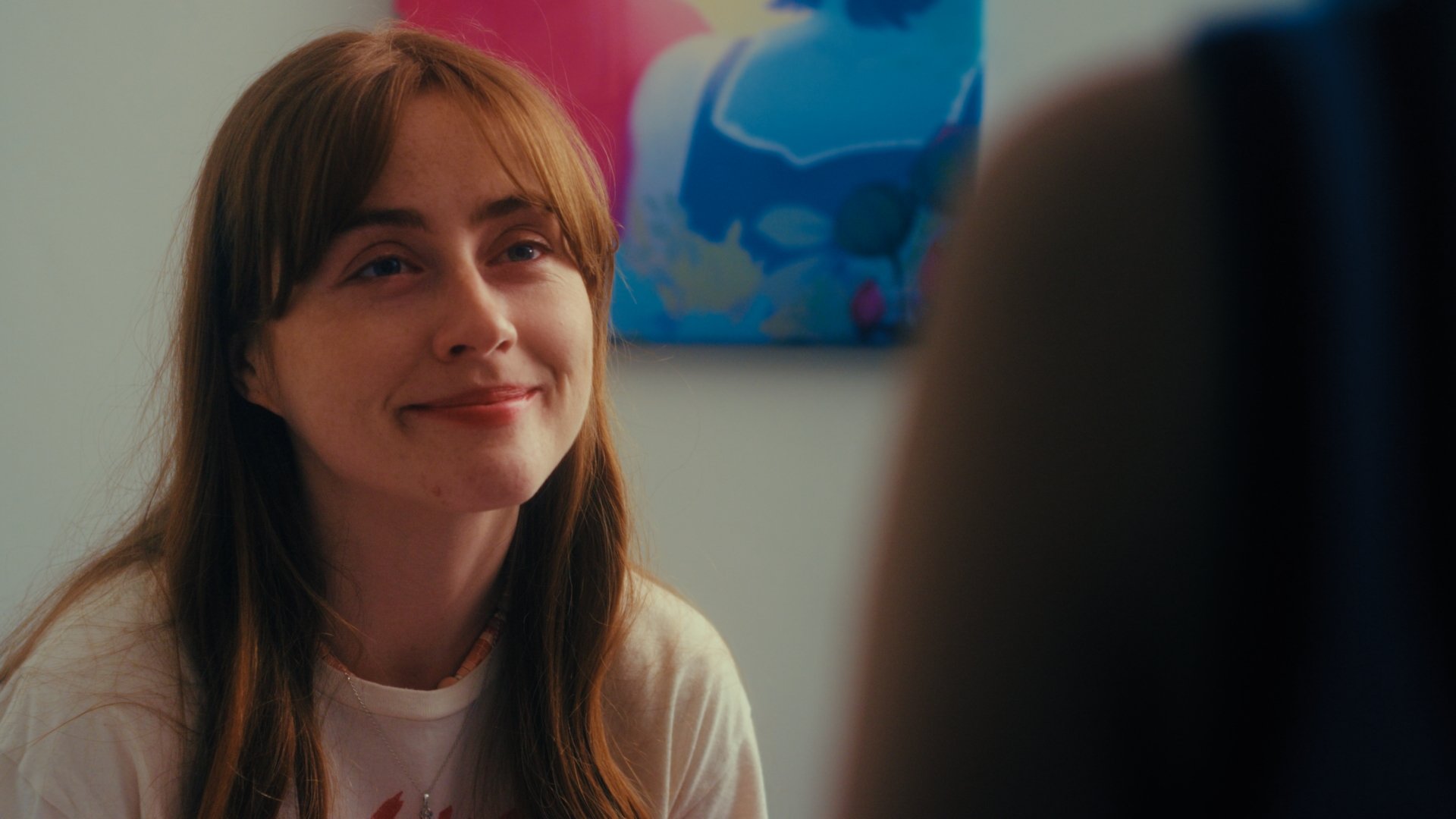 Woman smiles at her girlfriend.