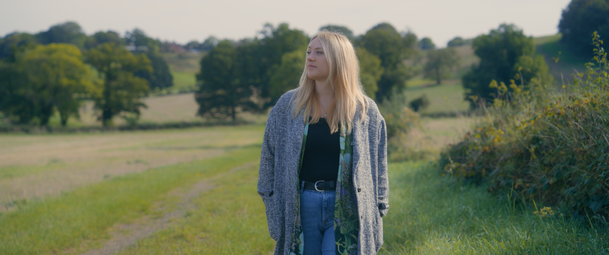 A medium shot of a woman in a field.