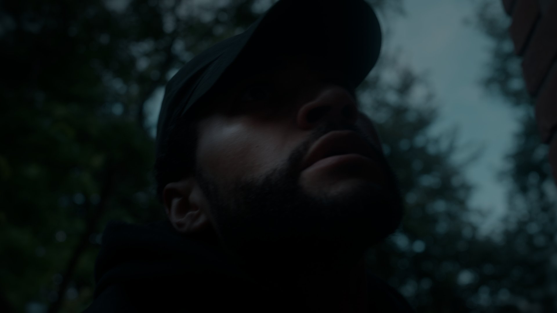 Low angle closeup of a man at night.