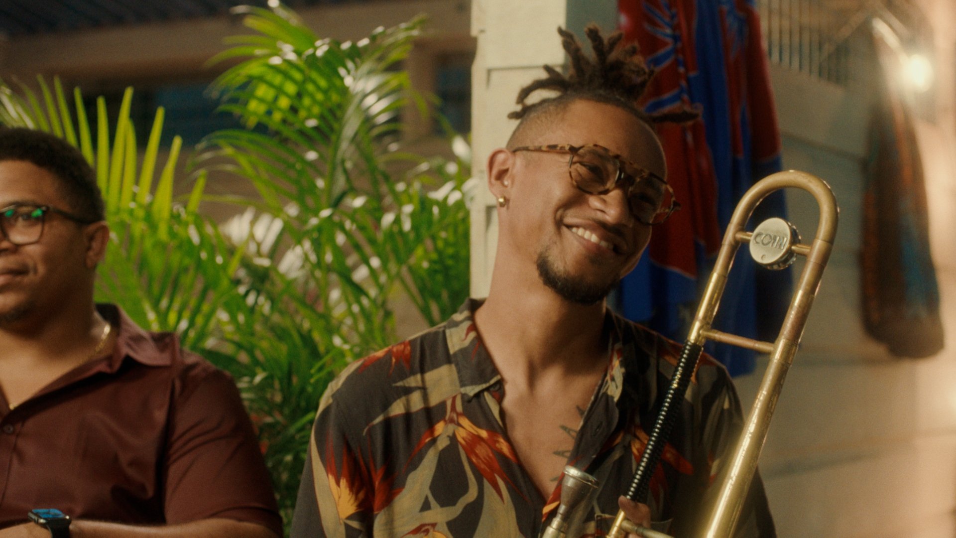 A man smiles with his musical instrument.