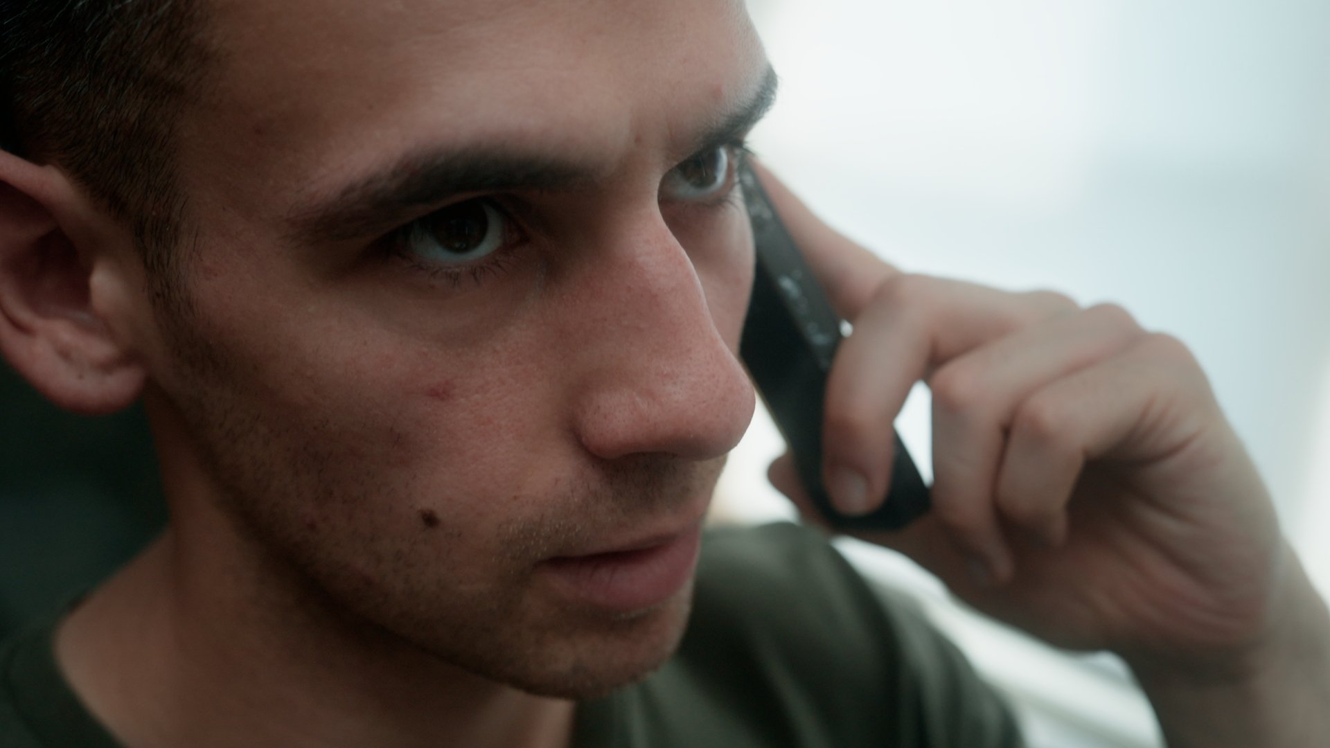 A man looks concerned on his phone call.